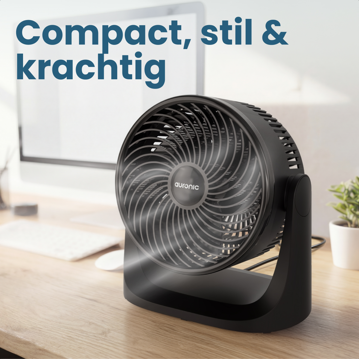 A black table fan with Auronic logo sits on a wooden desk.