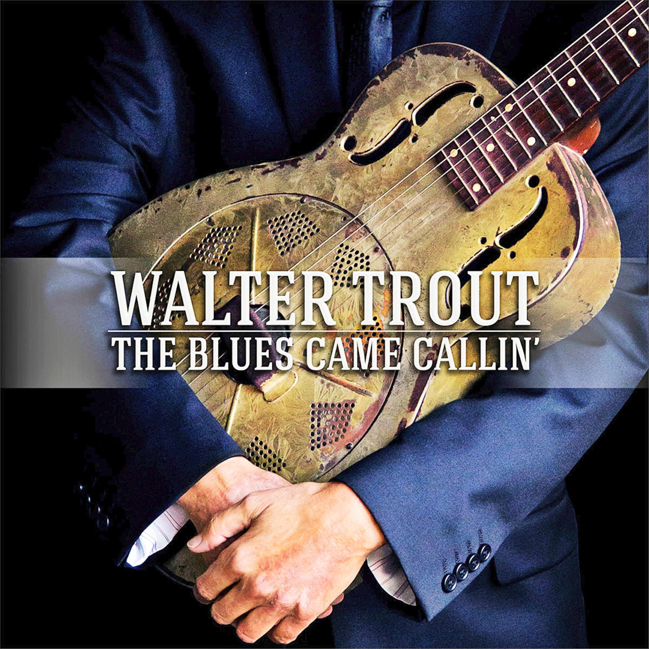 A man in a blue suit holds a dusty guitar. Walter Trout, The Blues Came Callin'.