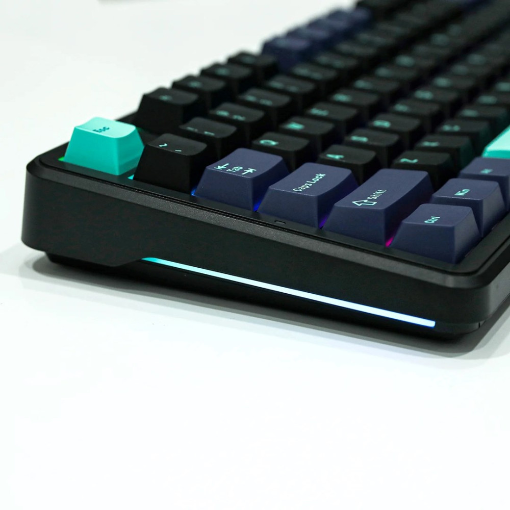 Zbliżenie czarnej klawiatury mechanicznej z klawiszami turkusowymi i granatowymi oraz oświetleniem RGB.