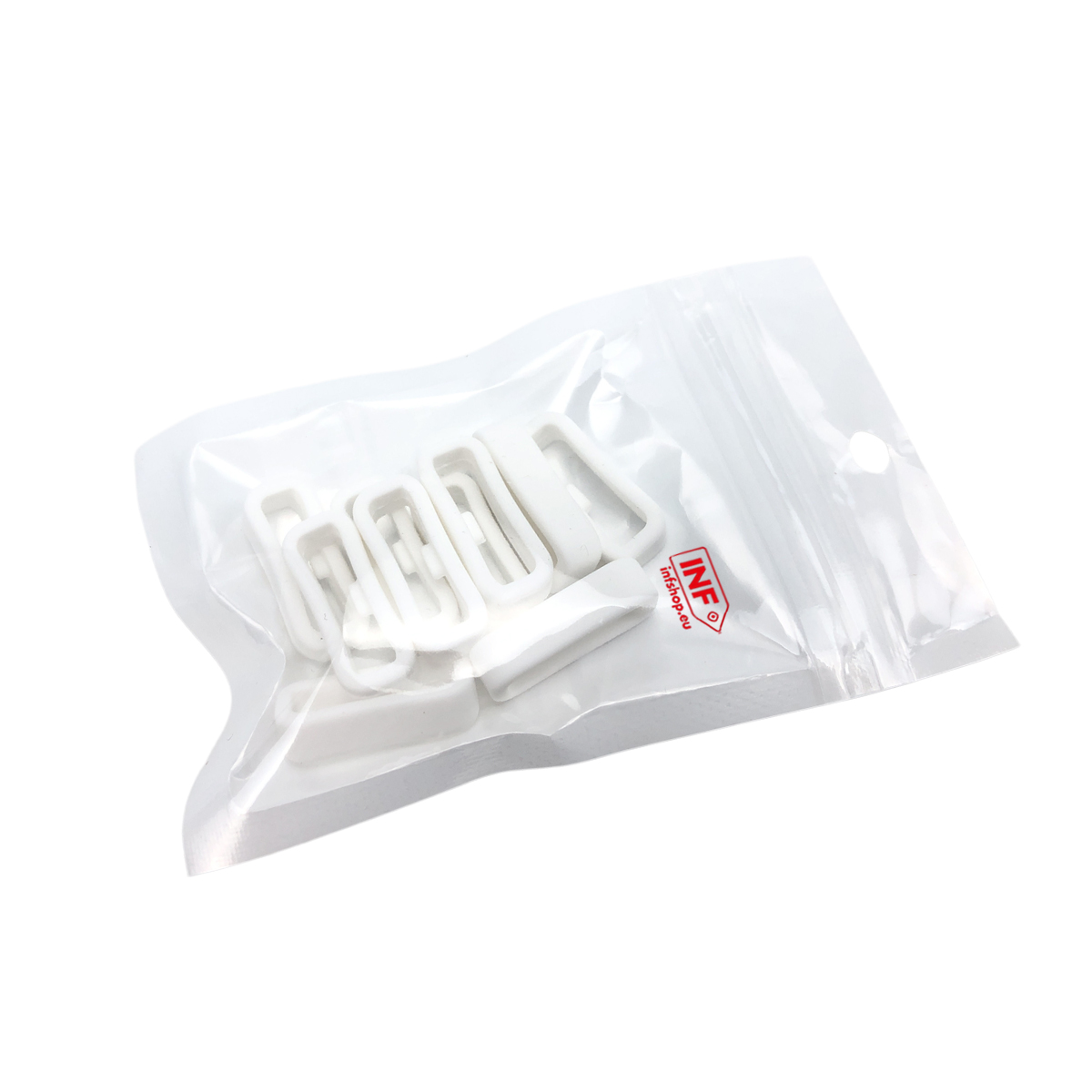 Weiße Kunststoff-BH-Trägerstopper in einer durchsichtigen Plastiktüte.