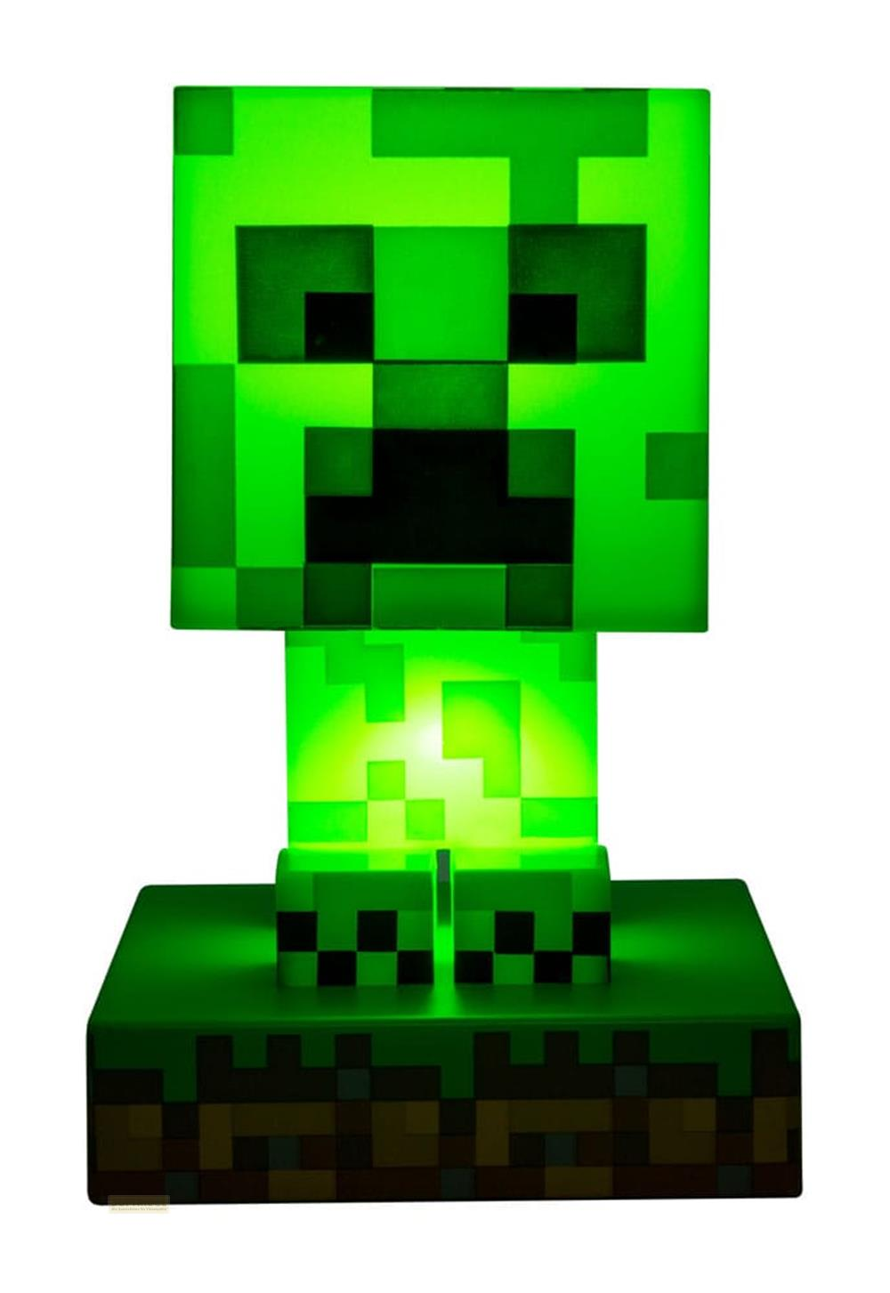 Zielona lampa Minecraft Creeper z pikselowymi detalami stoi na podstawie bloku trawy.