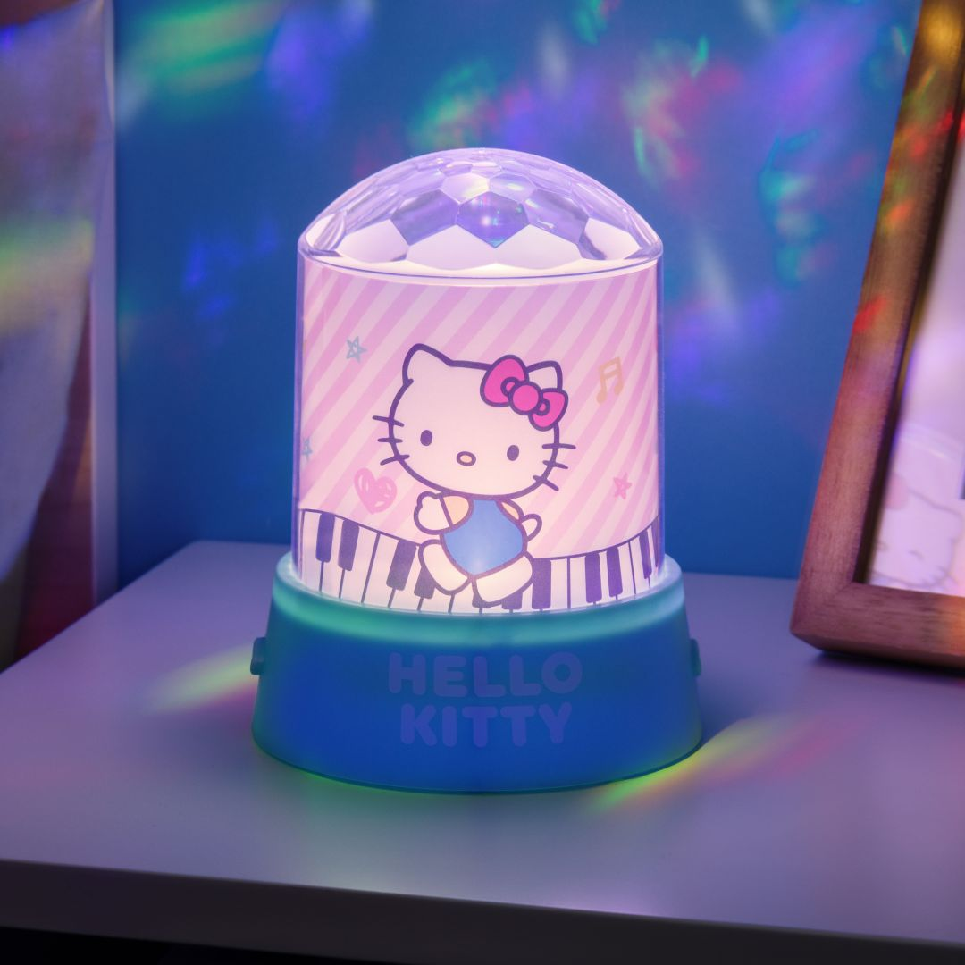 Lampka dyskotekowa Hello Kitty w różowe paski z klawiszami fortepianu.
