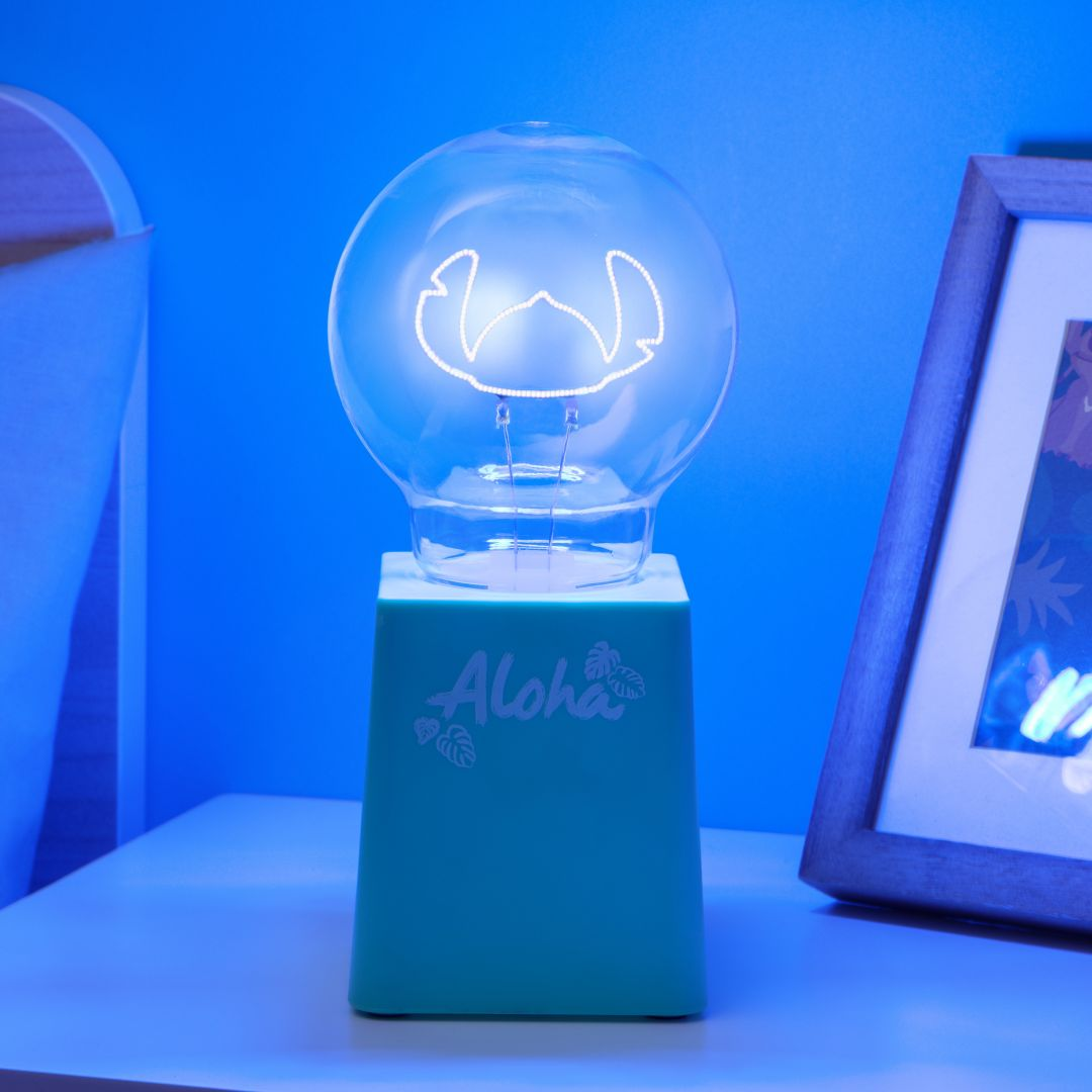 Żarówka z postacią Stitch stoi na turkusowej podstawie z napisem "Aloha".