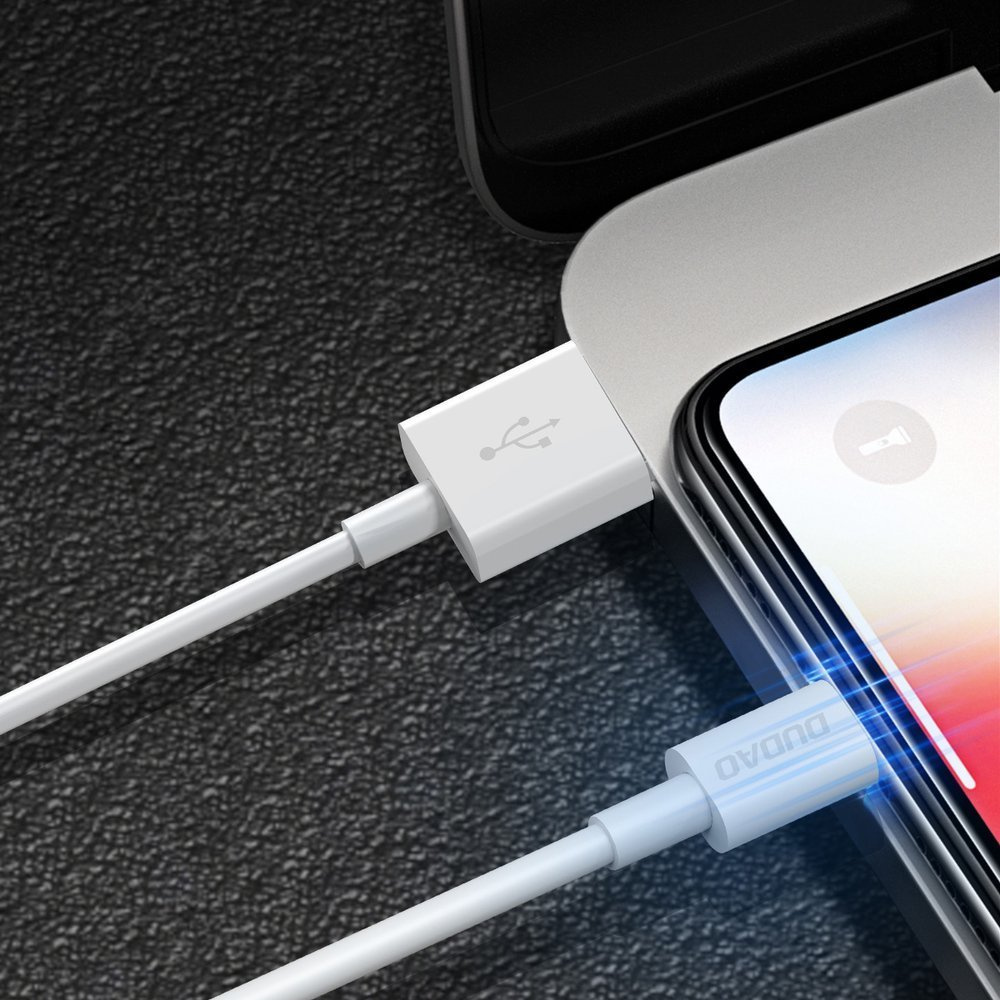 Un cavo USB bianco si collega a uno smartphone e a un laptop.