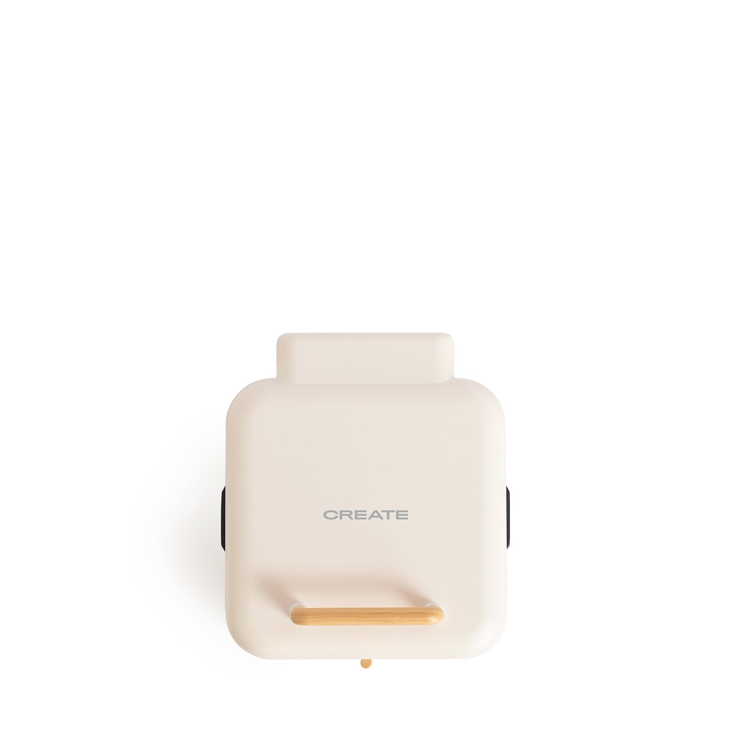 Una cafetera color crema con mango de madera, etiquetada 'CREATE'.