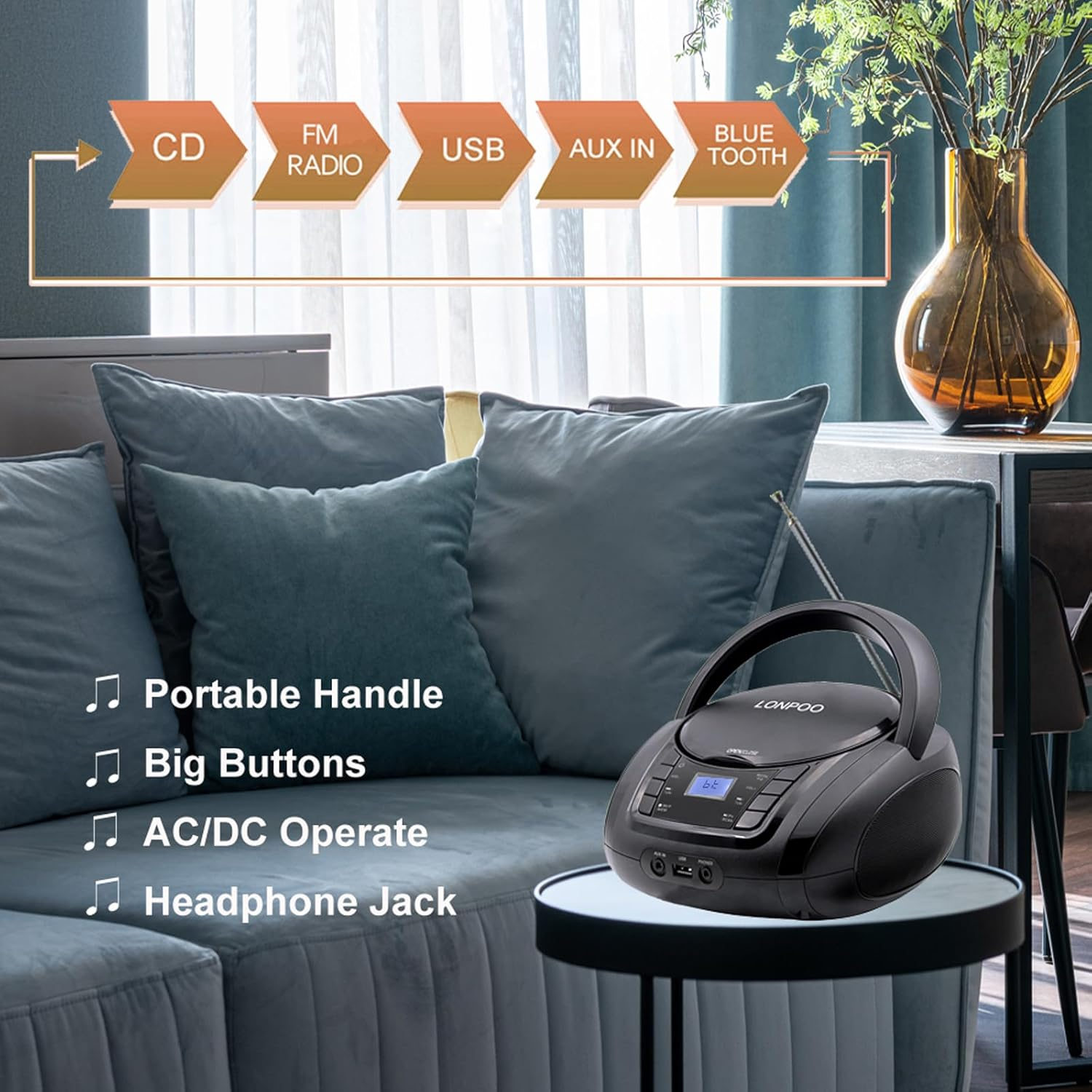 Schwarzer CD-Player mit Griff, Tasten, Anschlüssen auf einem Tisch neben Sofa.