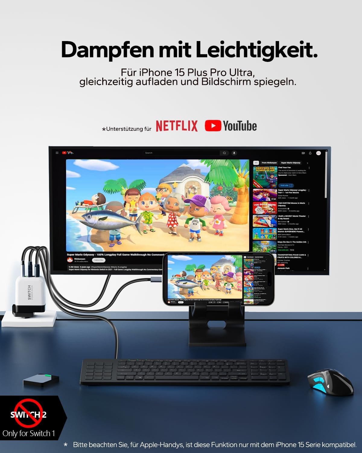 Ein iPhone spiegelt einen Computerbildschirm, der YouTube zeigt. Zubehör ist auf dem Schreibtisch abgebildet.