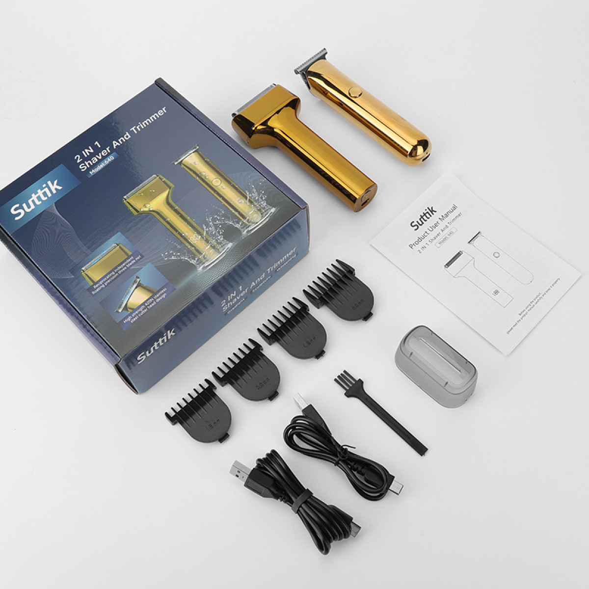 Goldene Haarschneidemaschine mit Zubehör und Verpackung auf weißem Hintergrund.