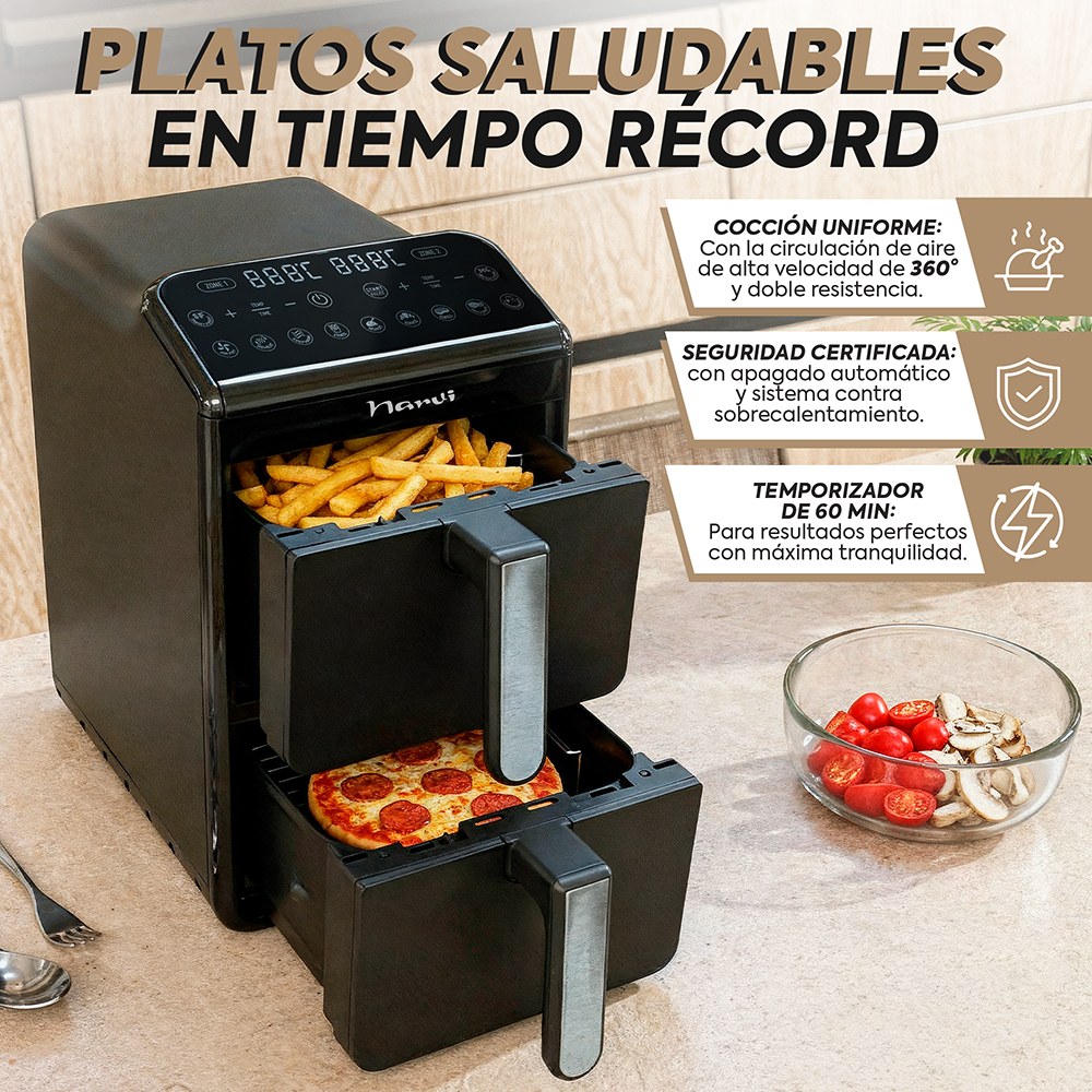 Una freidora de aire negra de doble cesta con papas fritas y pizza. Al lado, un tazón con tomates y champiñones.