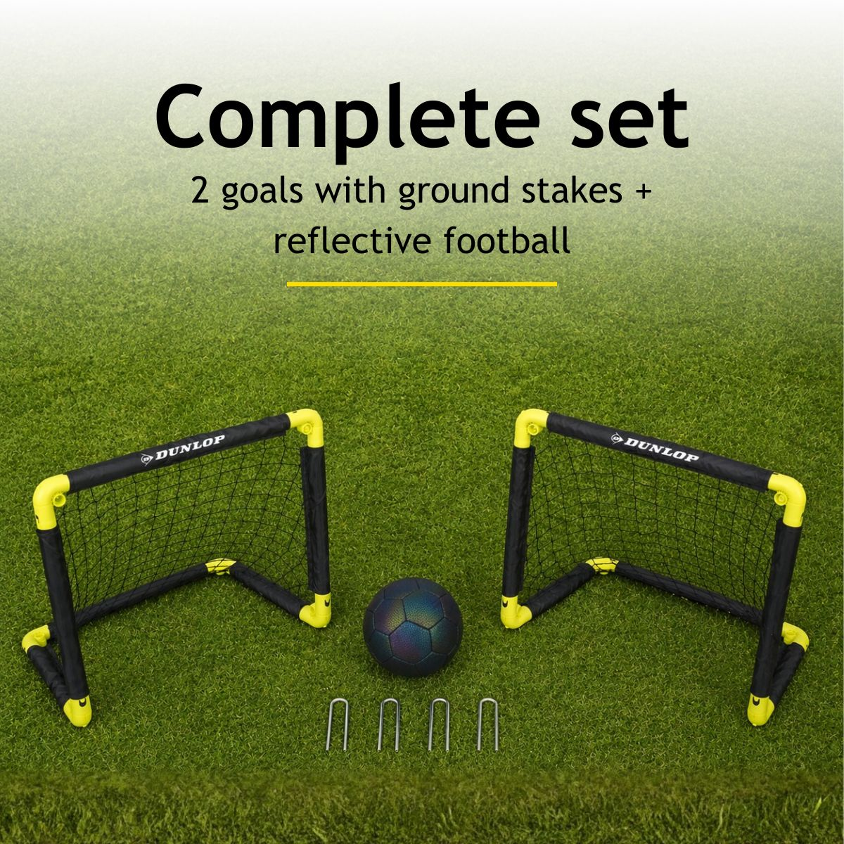 Two black and yellow soccer goals, a reflective ball, and four ground stakes on grass.