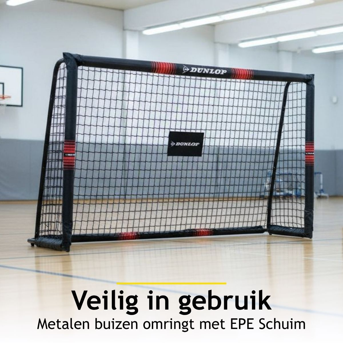 A black-netted goal with Dunlop logo in a gymnasium.