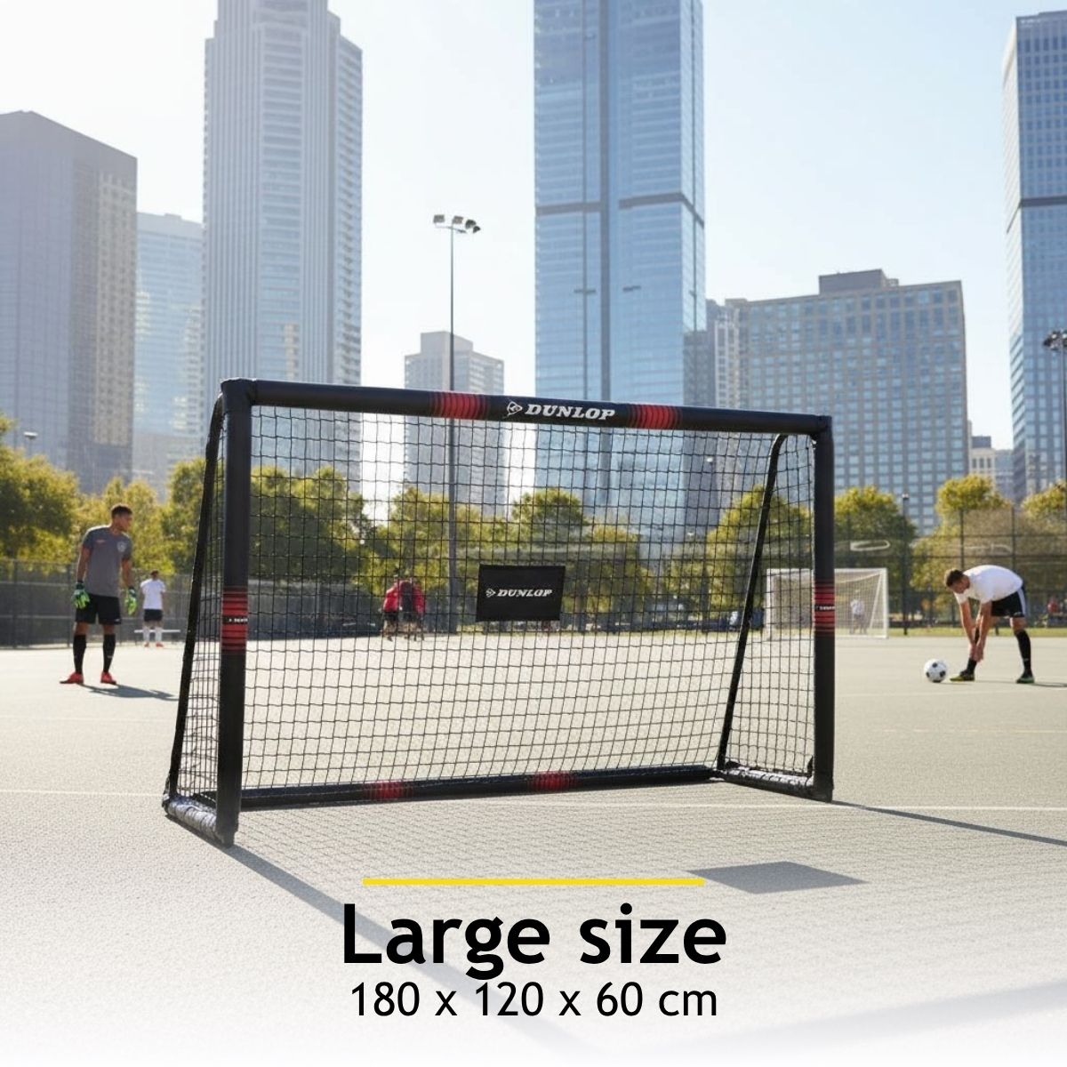 Soccer goal on an urban court with skyscrapers in the background.