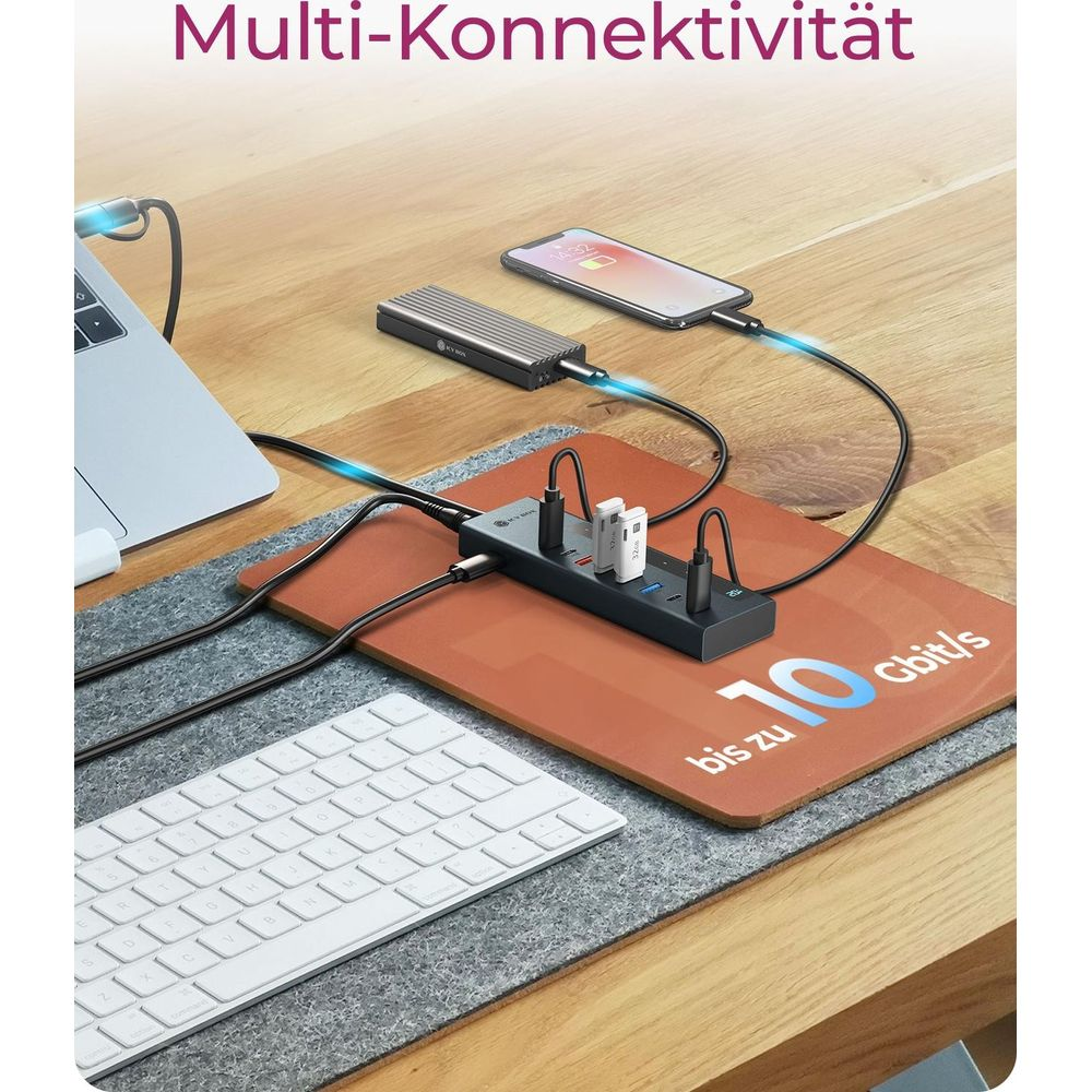 Laptop, Handy, SSD, Tastatur und Hub auf Schreibtisch. Text: Multi-Konnektivität bis zu 10 Gbit/s.