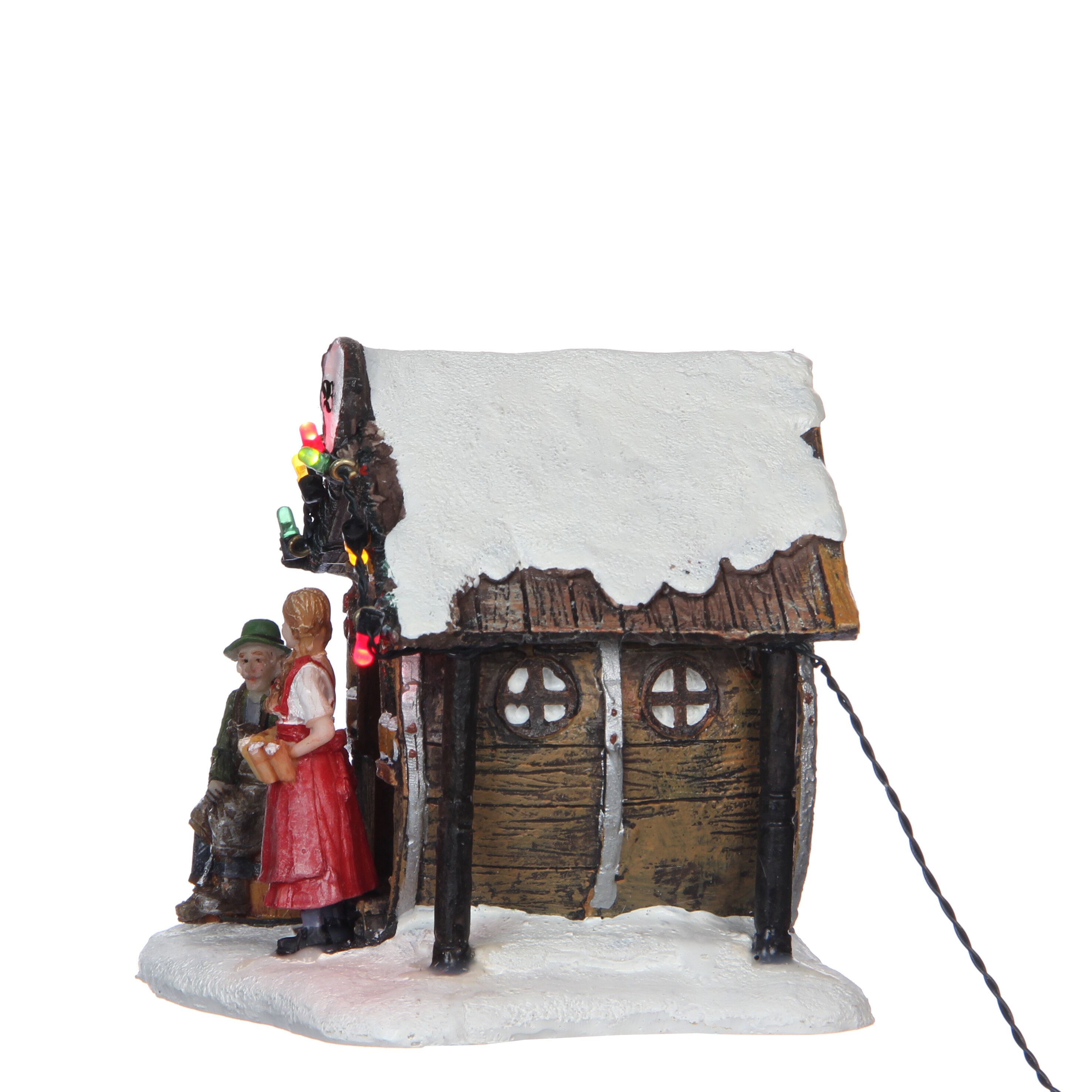 Een besneeuwd huis met lampjes en twee figuren ervoor.