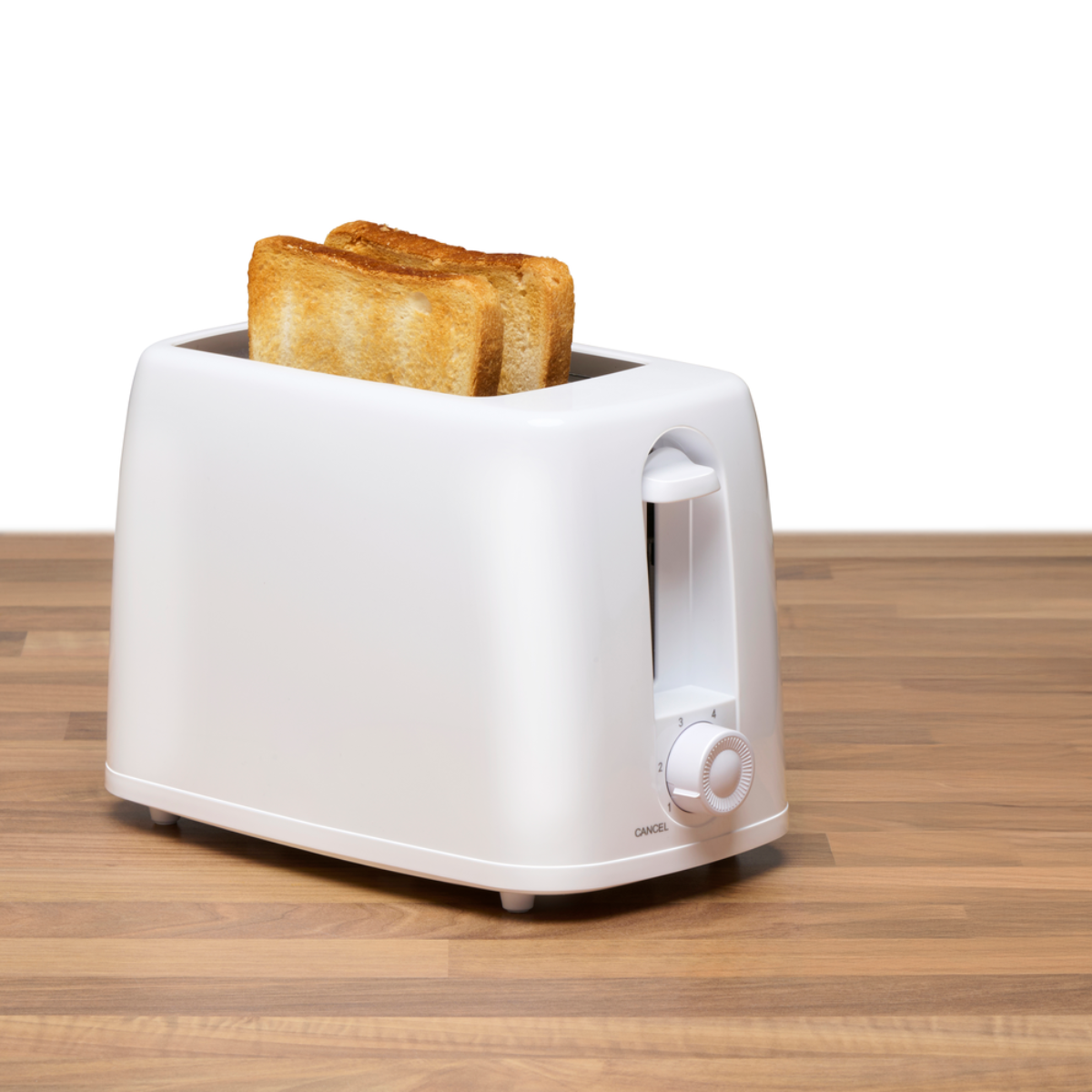 A white toaster with two slices of toast on a wooden surface.