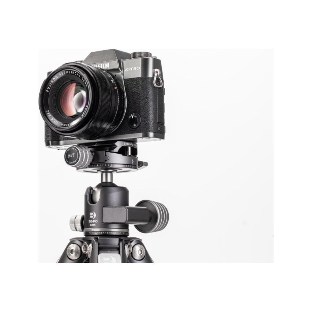 Una fotocamera nera con obiettivo FUJINON su un treppiede con testa.