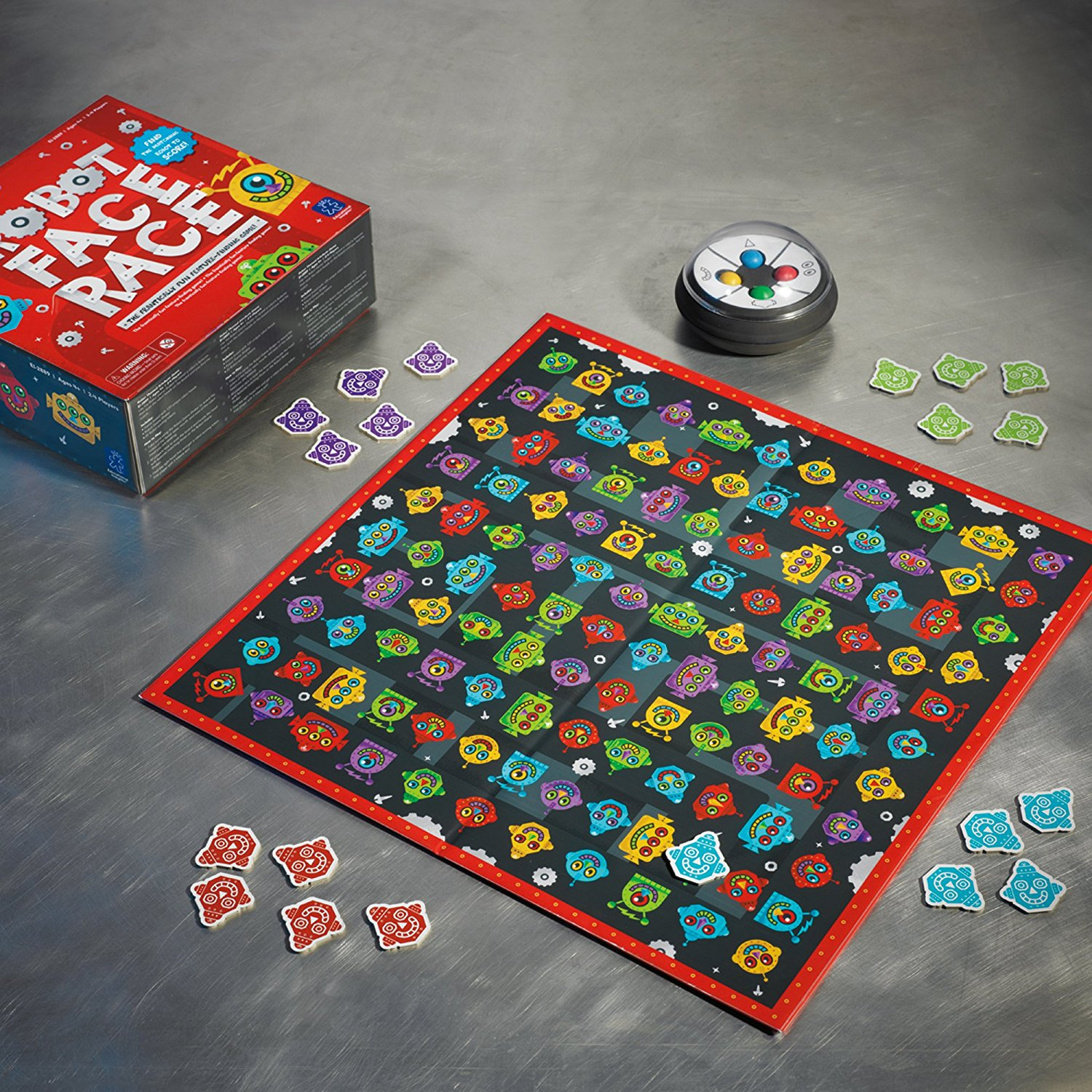 Un tablero de juego con muchas cabezas de robots coloridas, piezas y una caja.