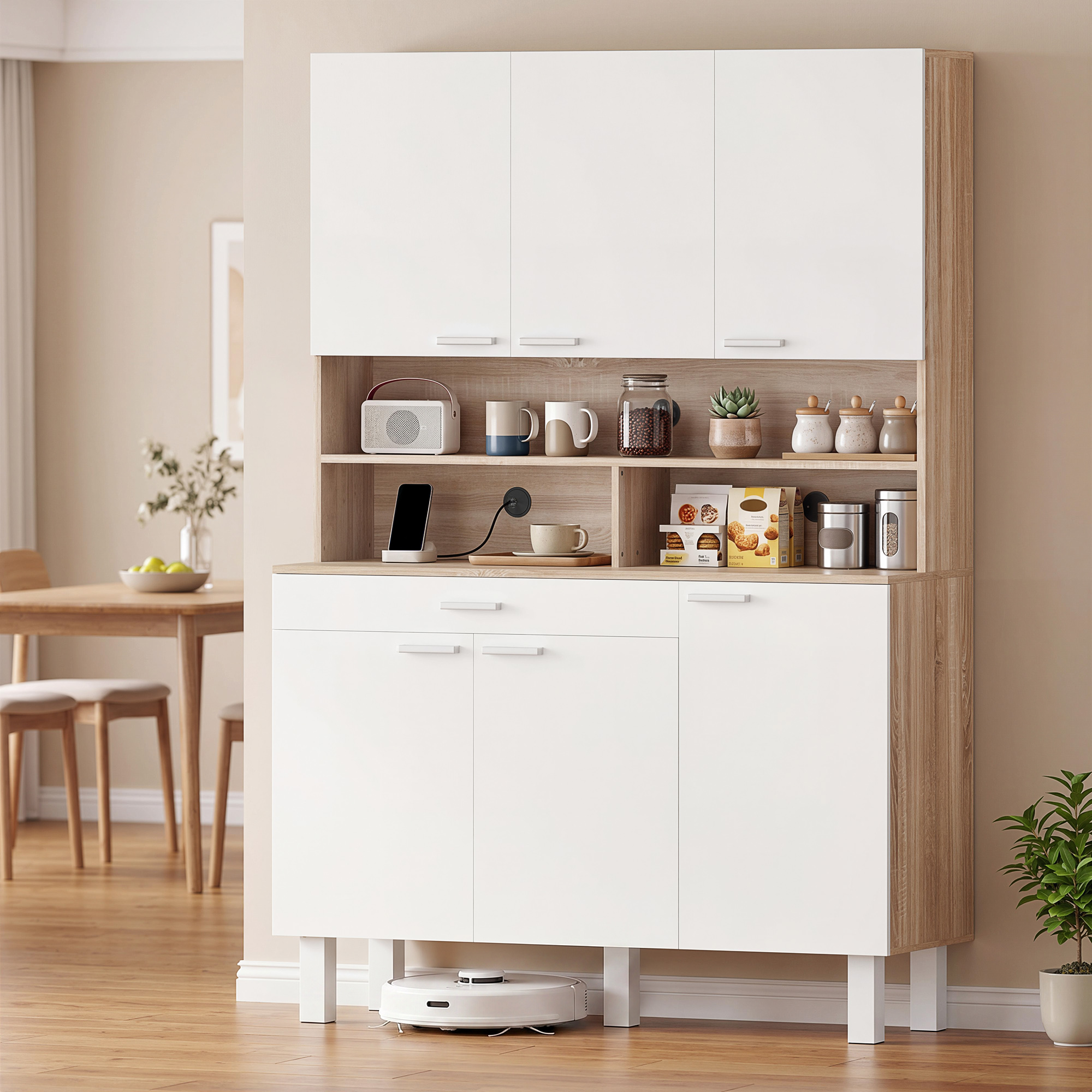 Una credenza da cucina bianca con accenti in legno, con tazze, radio, telefono, biscotti e piante.