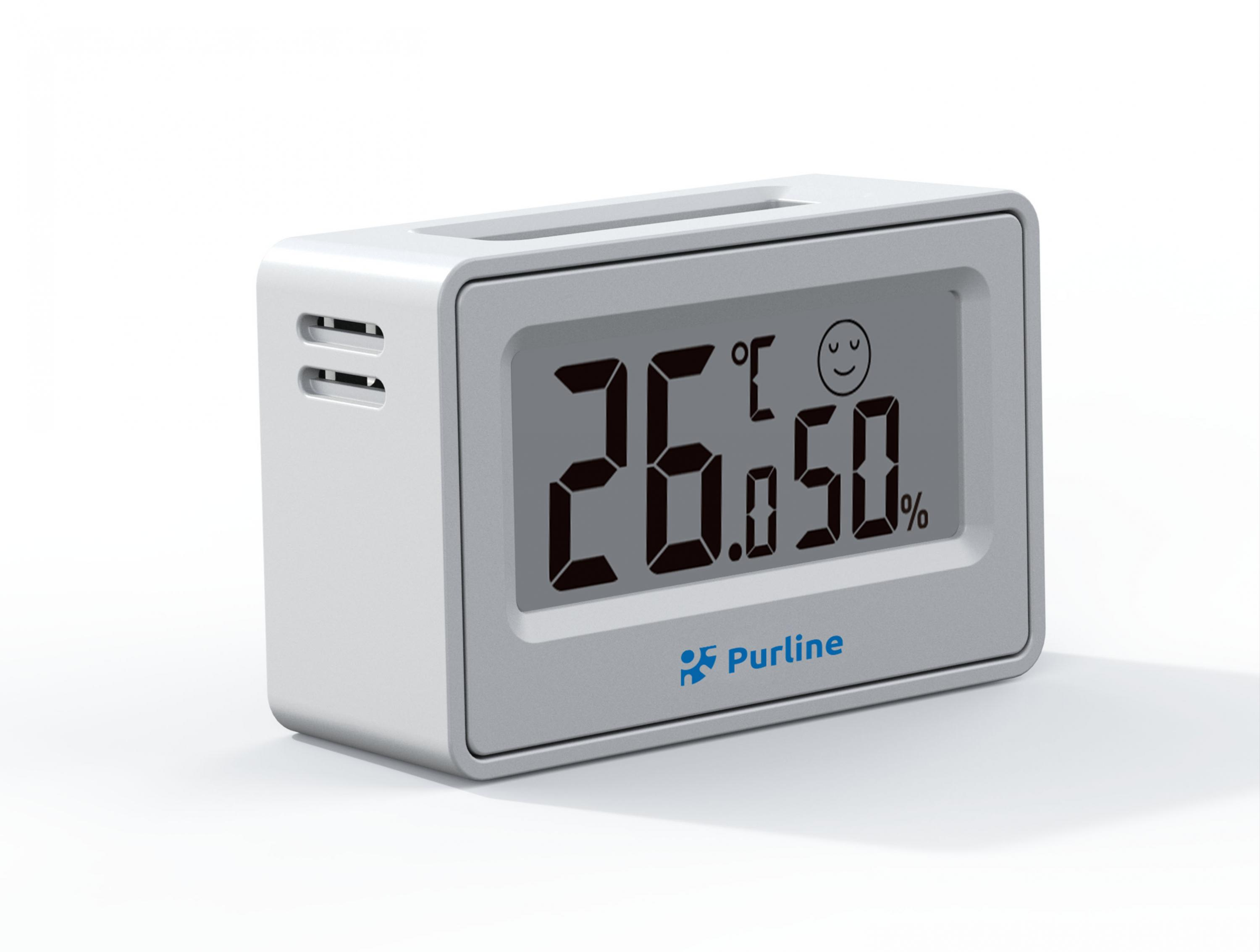Un termómetro/higrómetro digital blanco muestra 26,0 grados y 50% de humedad.