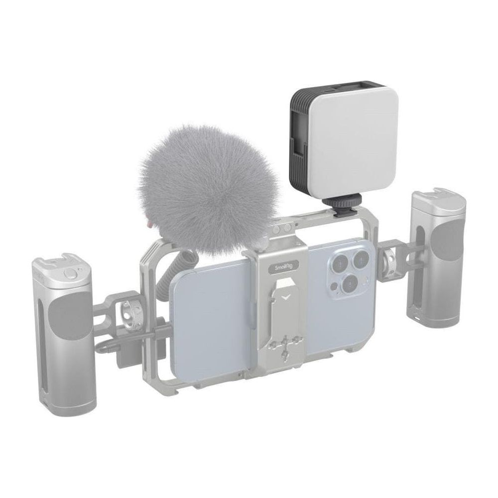 Smartphone rig met microfoon, licht en handgrepen op witte achtergrond.