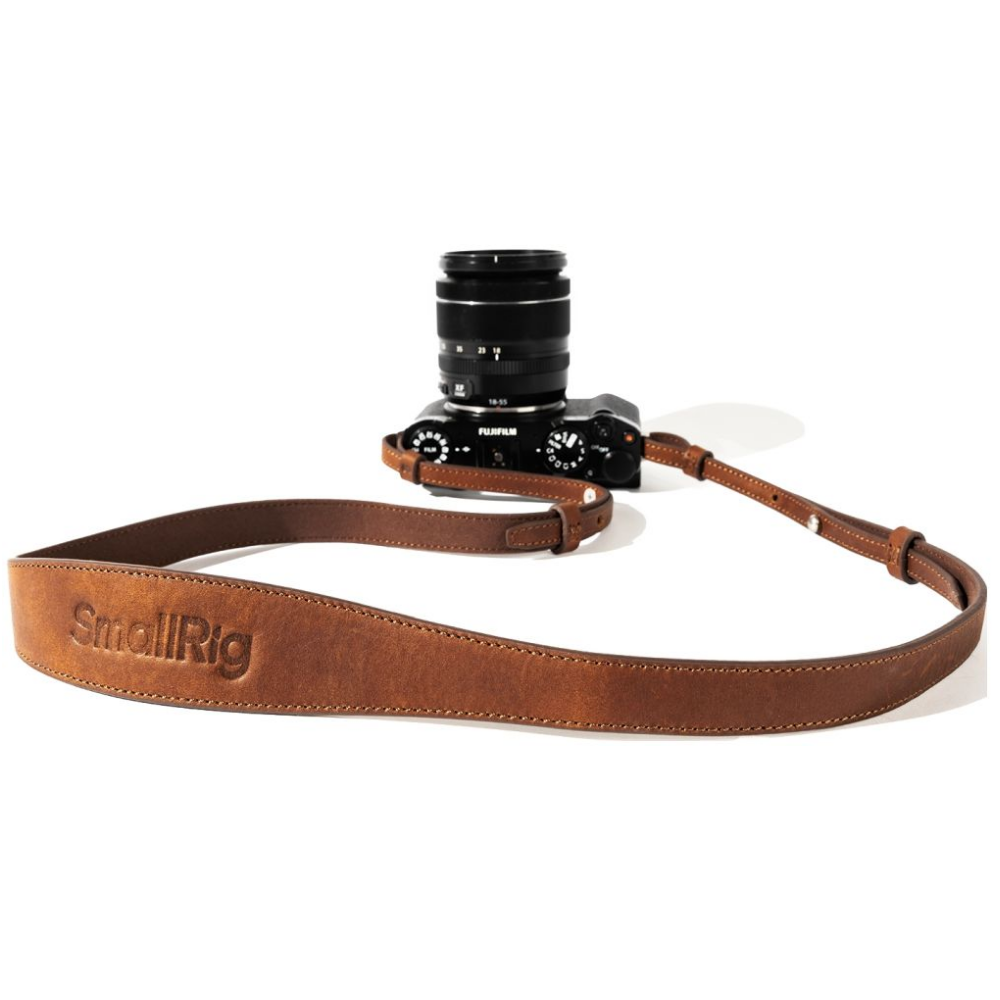 Bruine leren camerariem met een kleine zwarte camera.