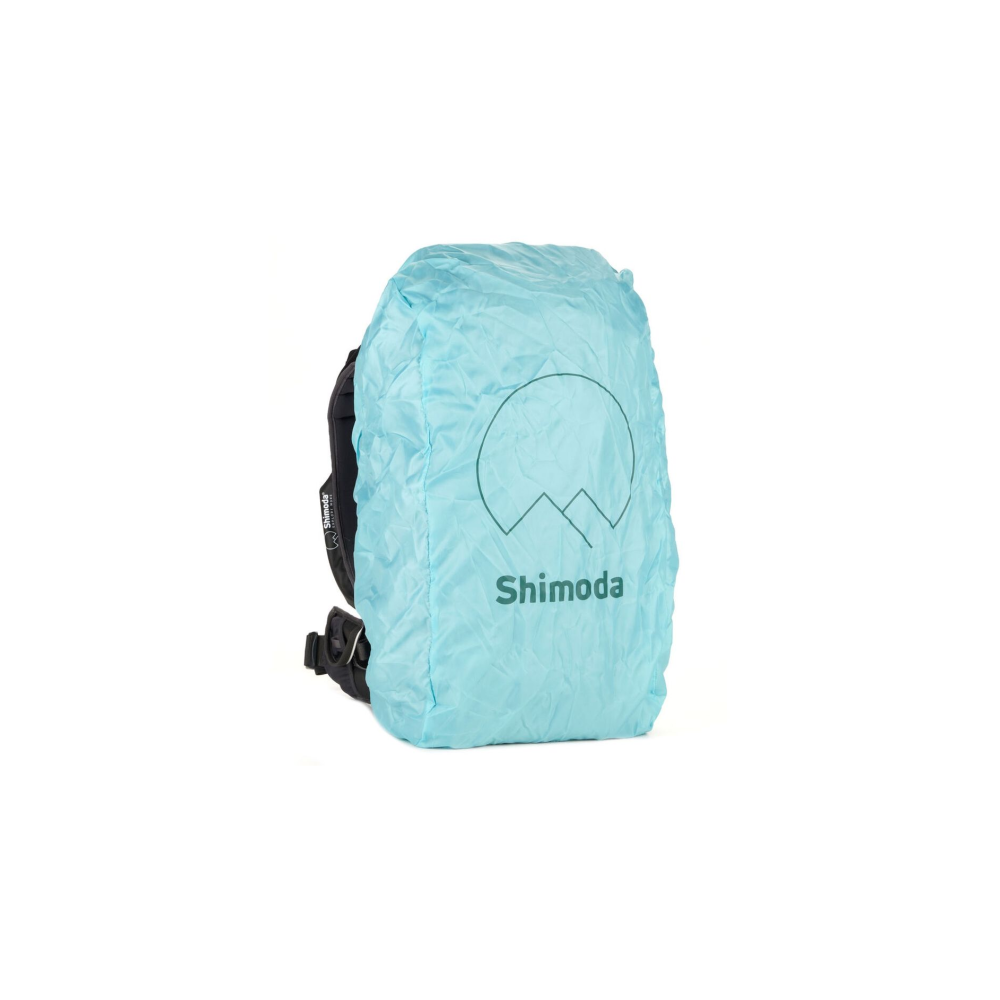Een lichtblauwe rugzakhoes met Shimoda logo en bergmotief.