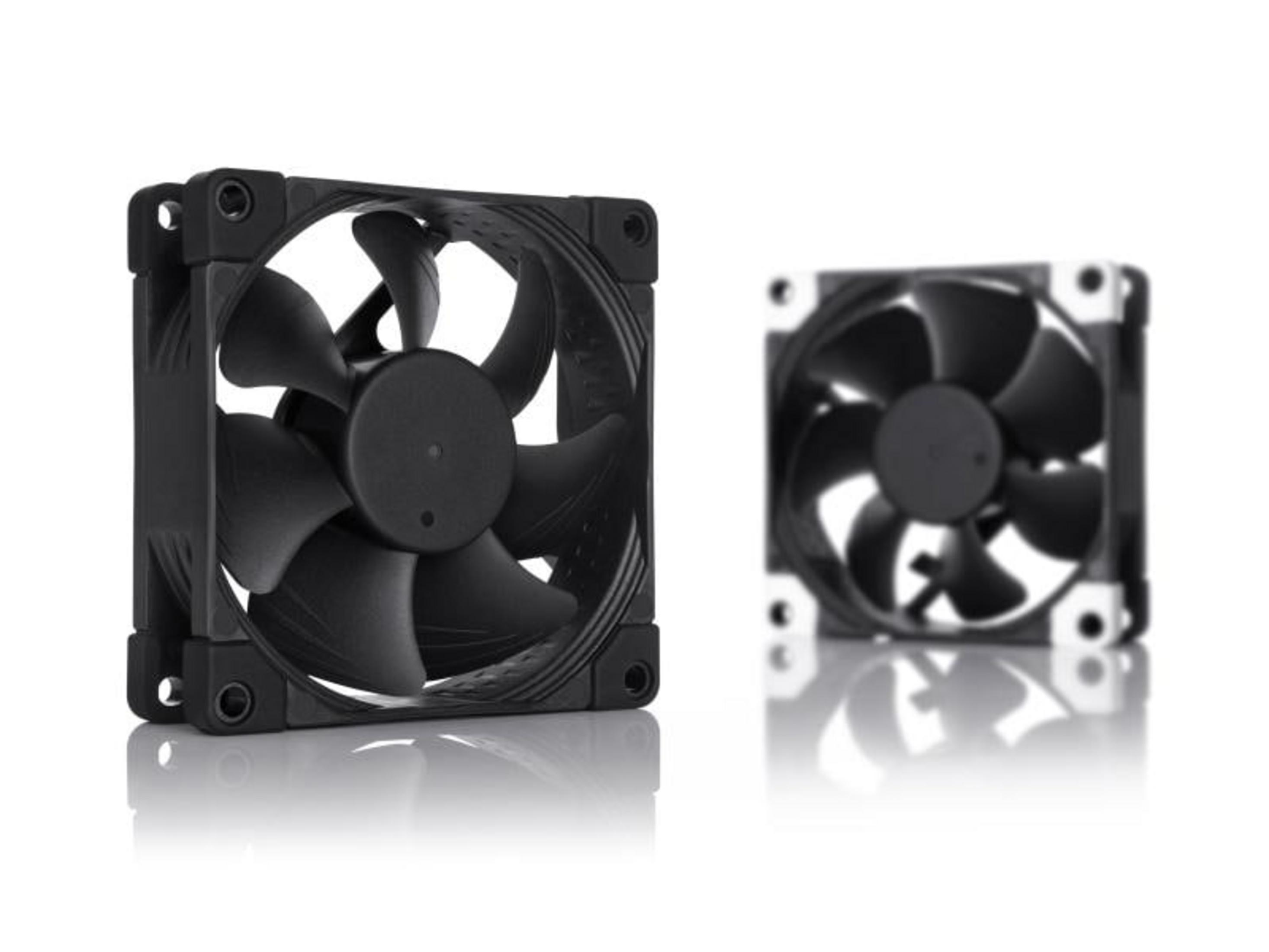 Two black computer fans with blades on a white reflective surface.