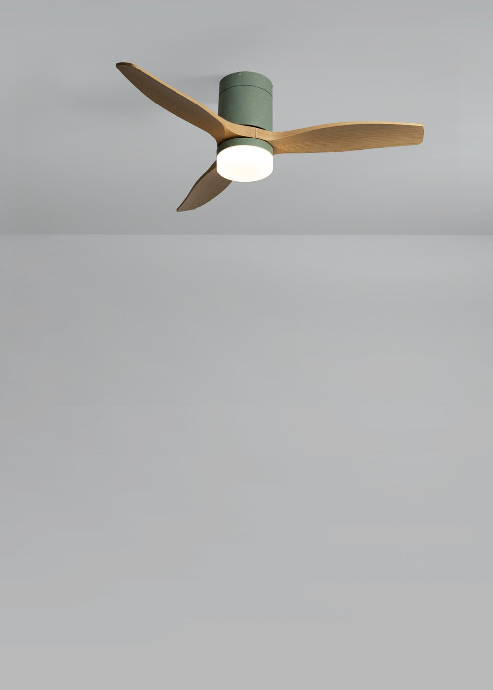 Ventilador de techo con tres aspas de madera, carcasa verde y luz redonda.