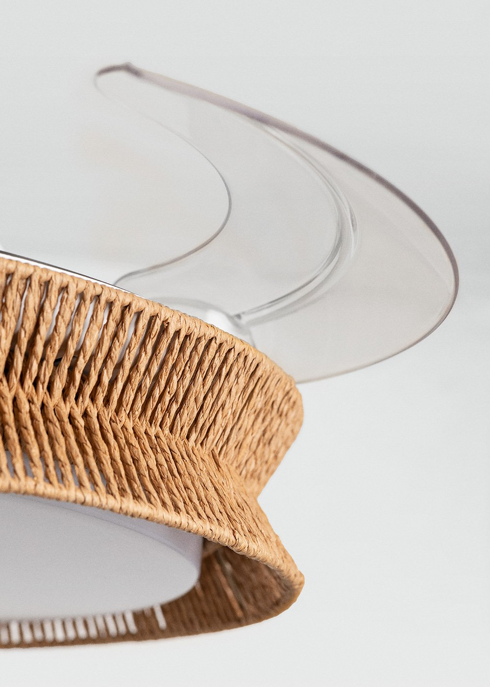 Ventilador de techo con detalle de cesta tejida y aspas transparentes.