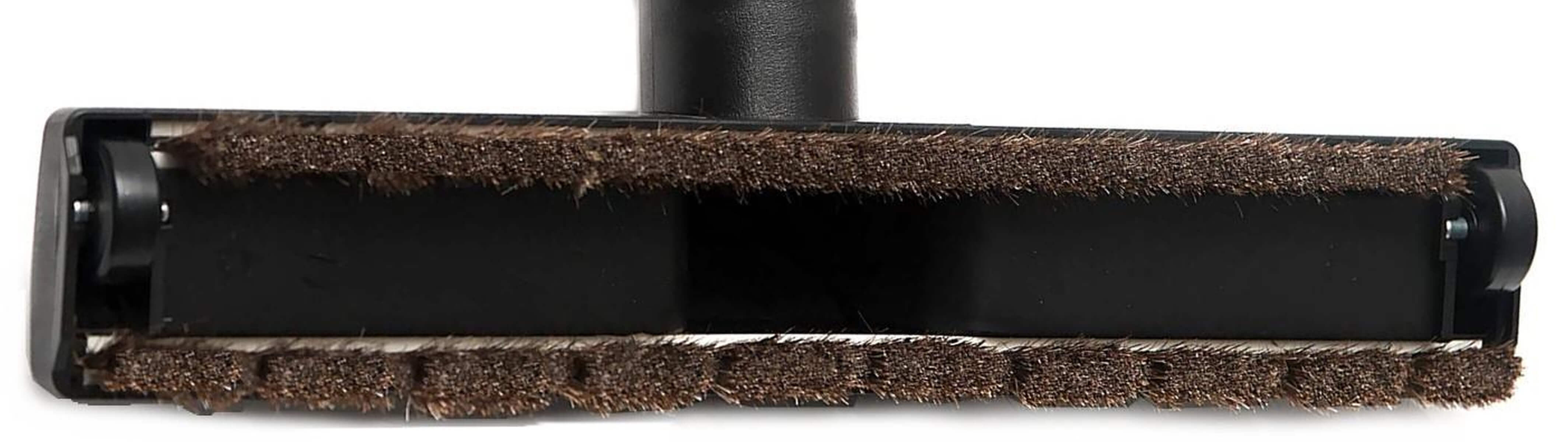 Brosse d'aspirateur noire avec poils marron sur fond blanc.