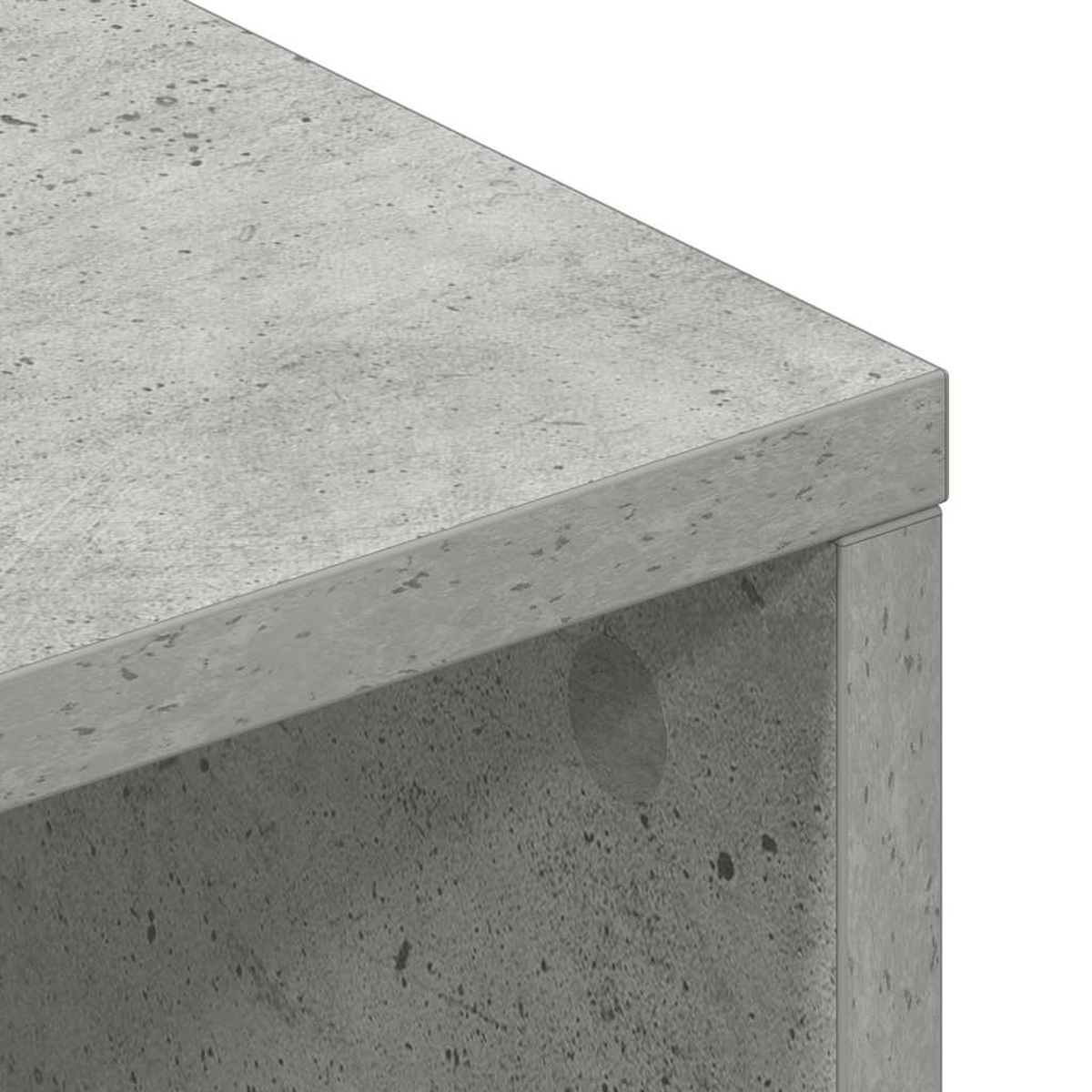 Superficie de hormigón gris con motas oscuras, primer plano.