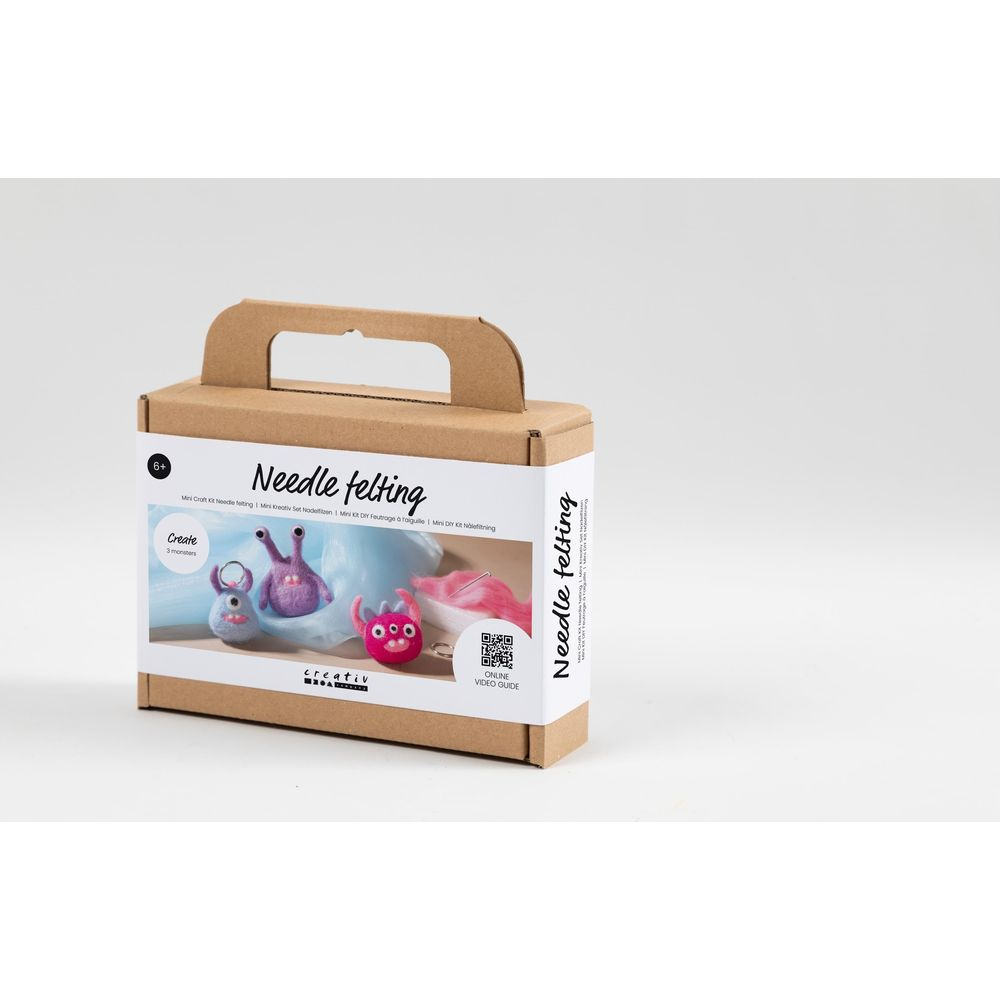 Eine Nadel-Filz-Bastelbox mit drei bunten Filzmonstern.