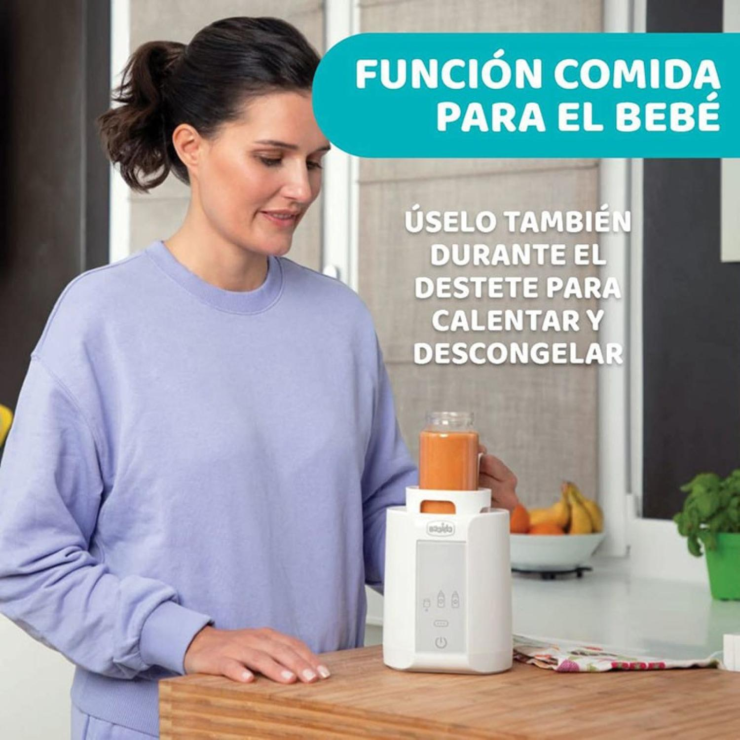 Una donna usa un dispositivo per scaldare il cibo per bambini. Frutta sullo sfondo.
