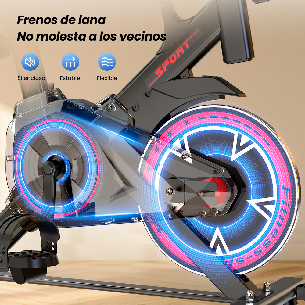 Primer plano de una bicicleta de ejercicio negra con detalles azules y rojos brillantes en el volante.