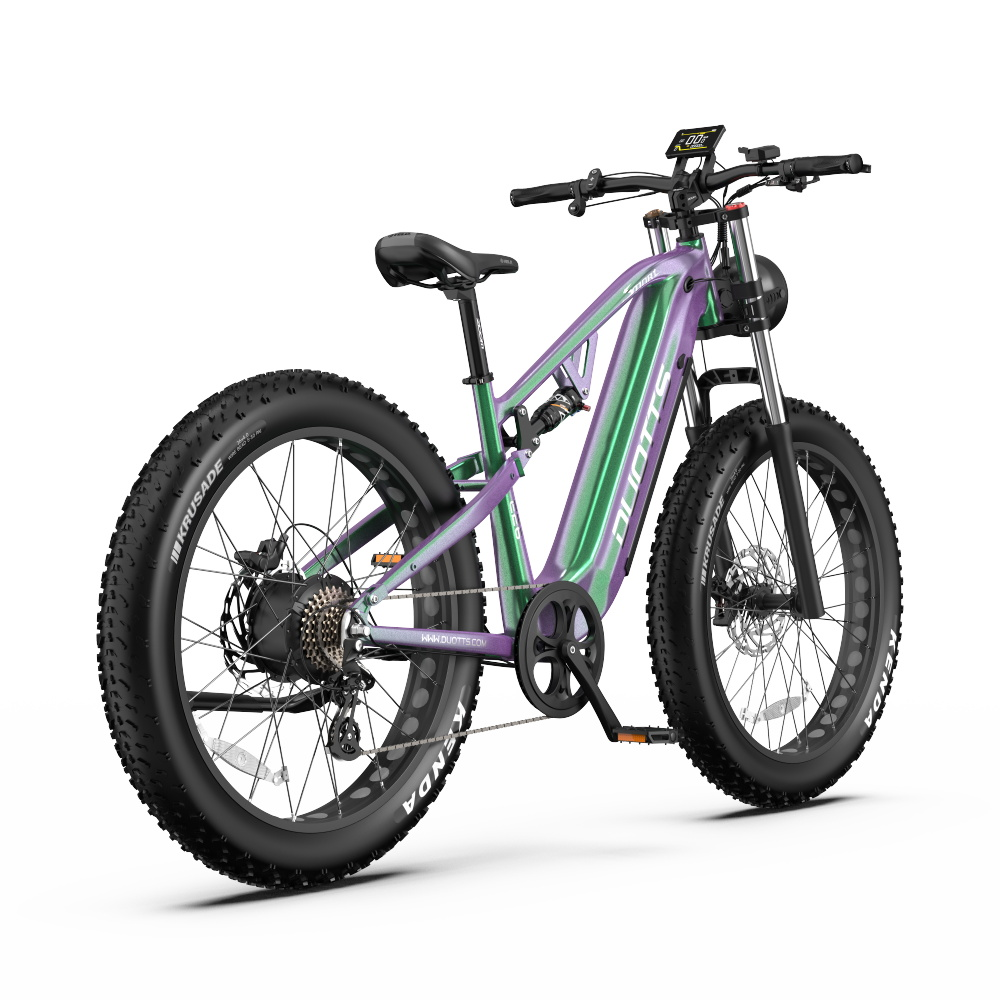 Fioletowo-zielony elektryczny rower fatbike z amortyzacją i wyświetlaczem.