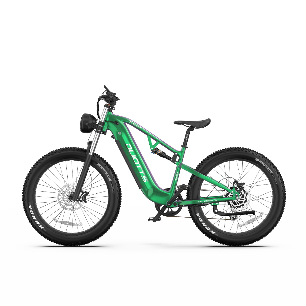 Zielony elektryczny rower fatbike z szerokimi oponami, amortyzacją i okrągłym reflektorem.