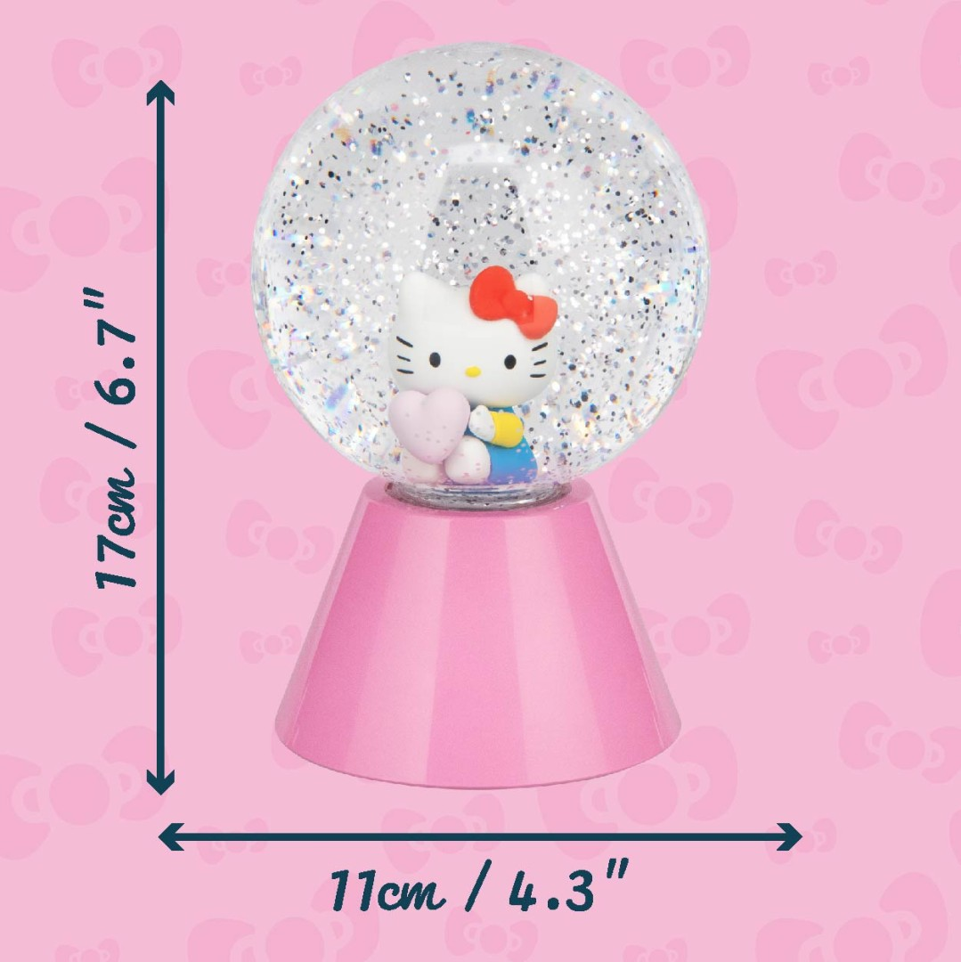 Kula śnieżna Hello Kitty z brokatem i sercami na różowym tle.