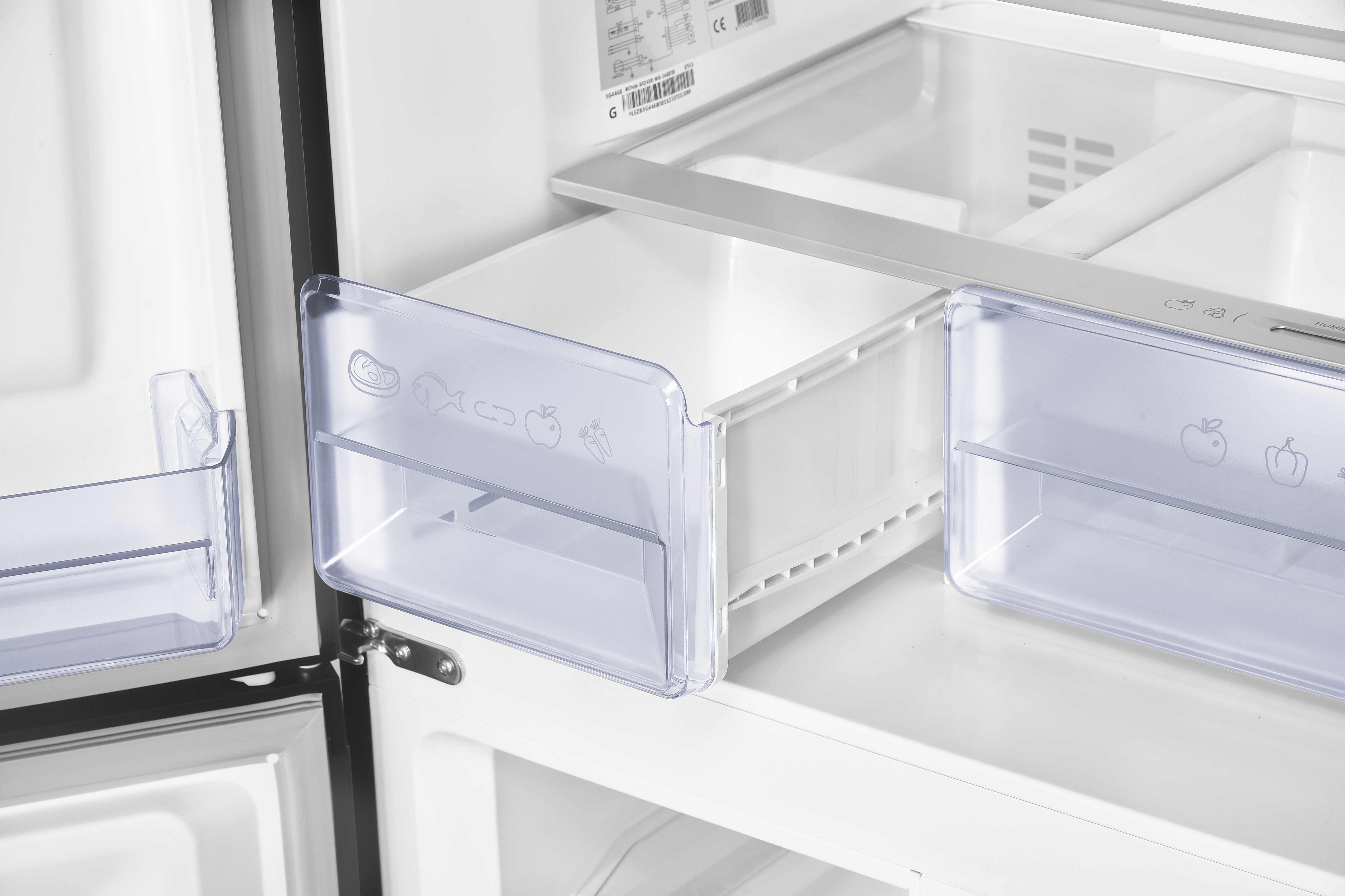 Interior view of a refrigerator with clear drawers and shelves.