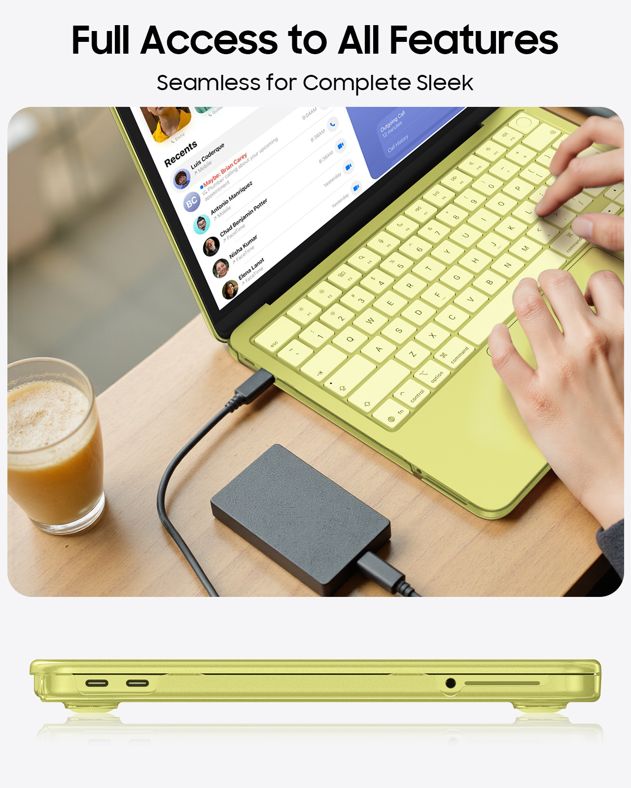 Ein hellgrünes Notebook mit externer Festplatte und einem Glas Saft.