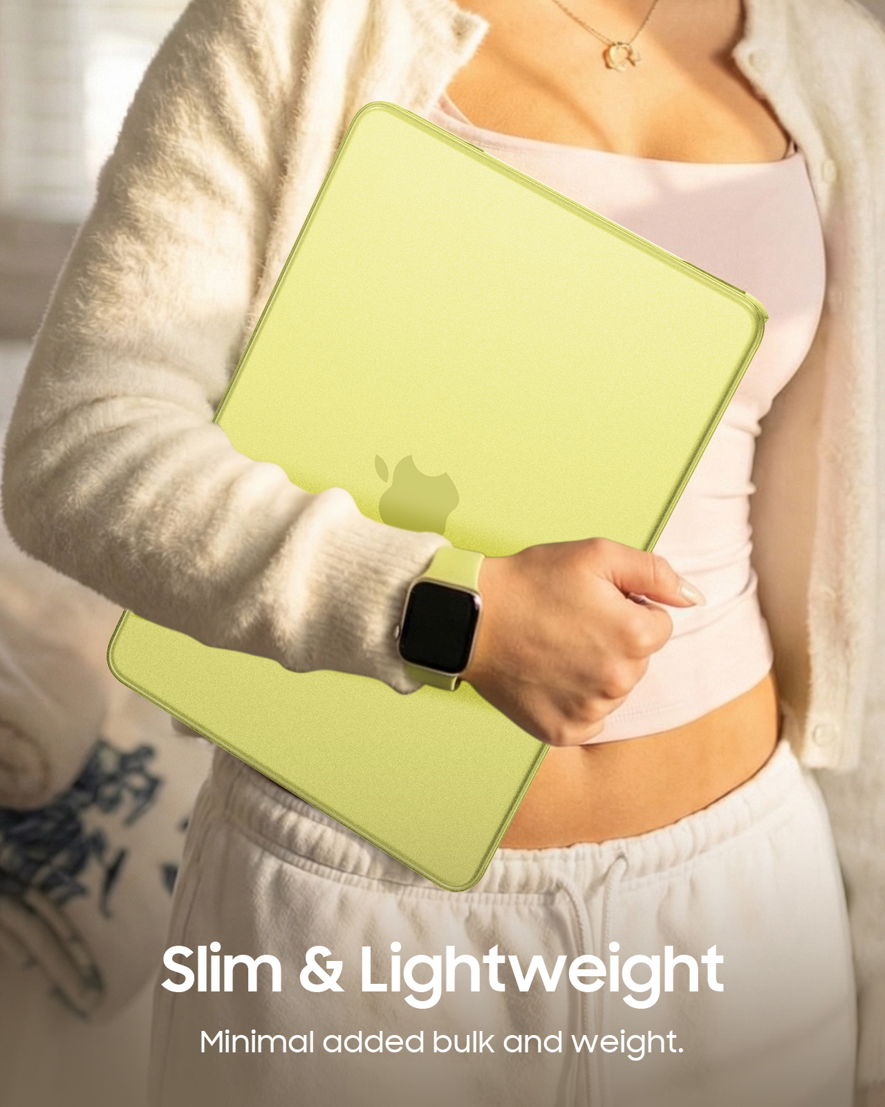 Eine Person hält ein hellgrünes Apple-Tablet mit einer Apple Watch am Handgelenk.