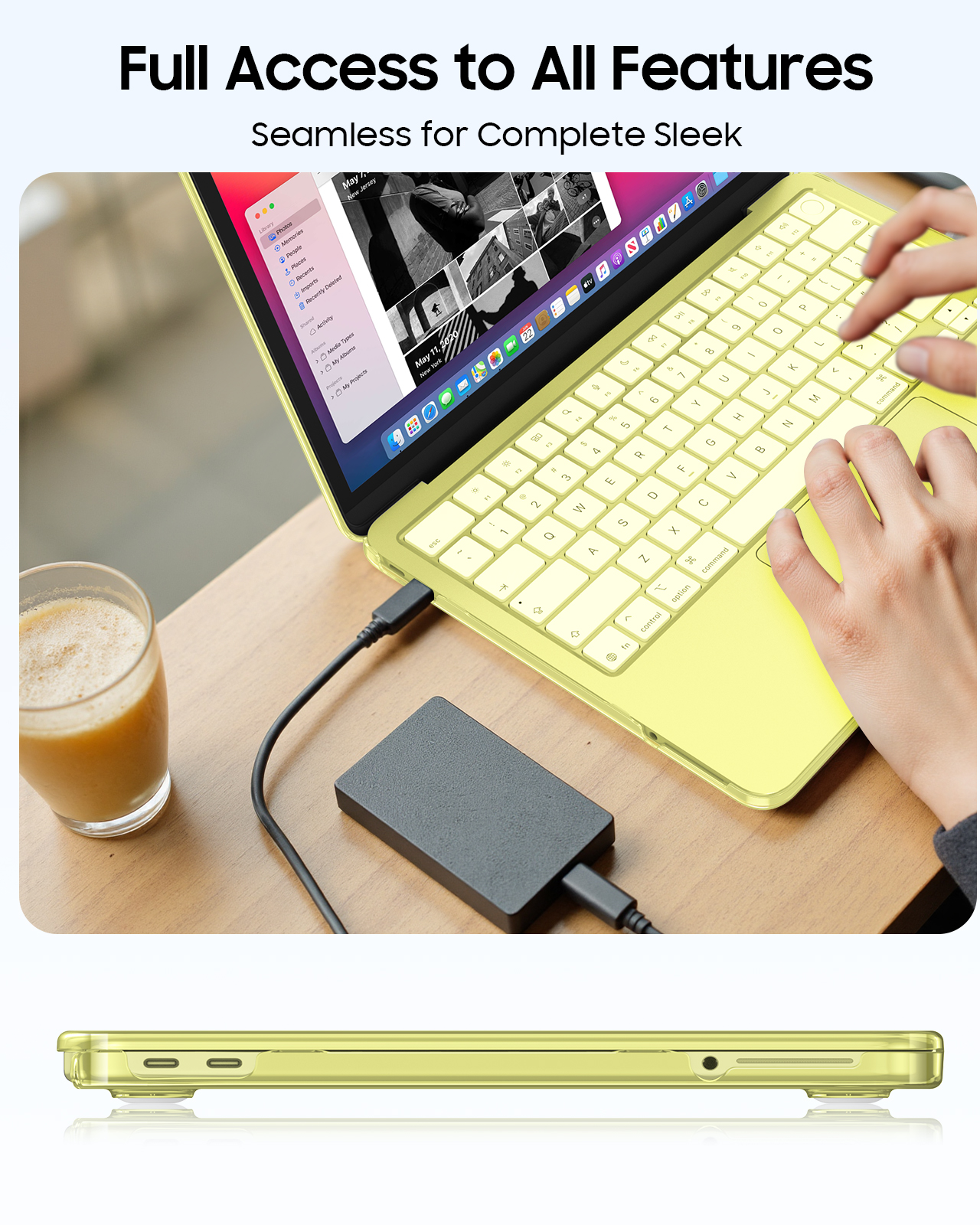 Ein gelbes Laptop mit Tastatur und einem Glas Getränk daneben, mit externer Festplatte verbunden.