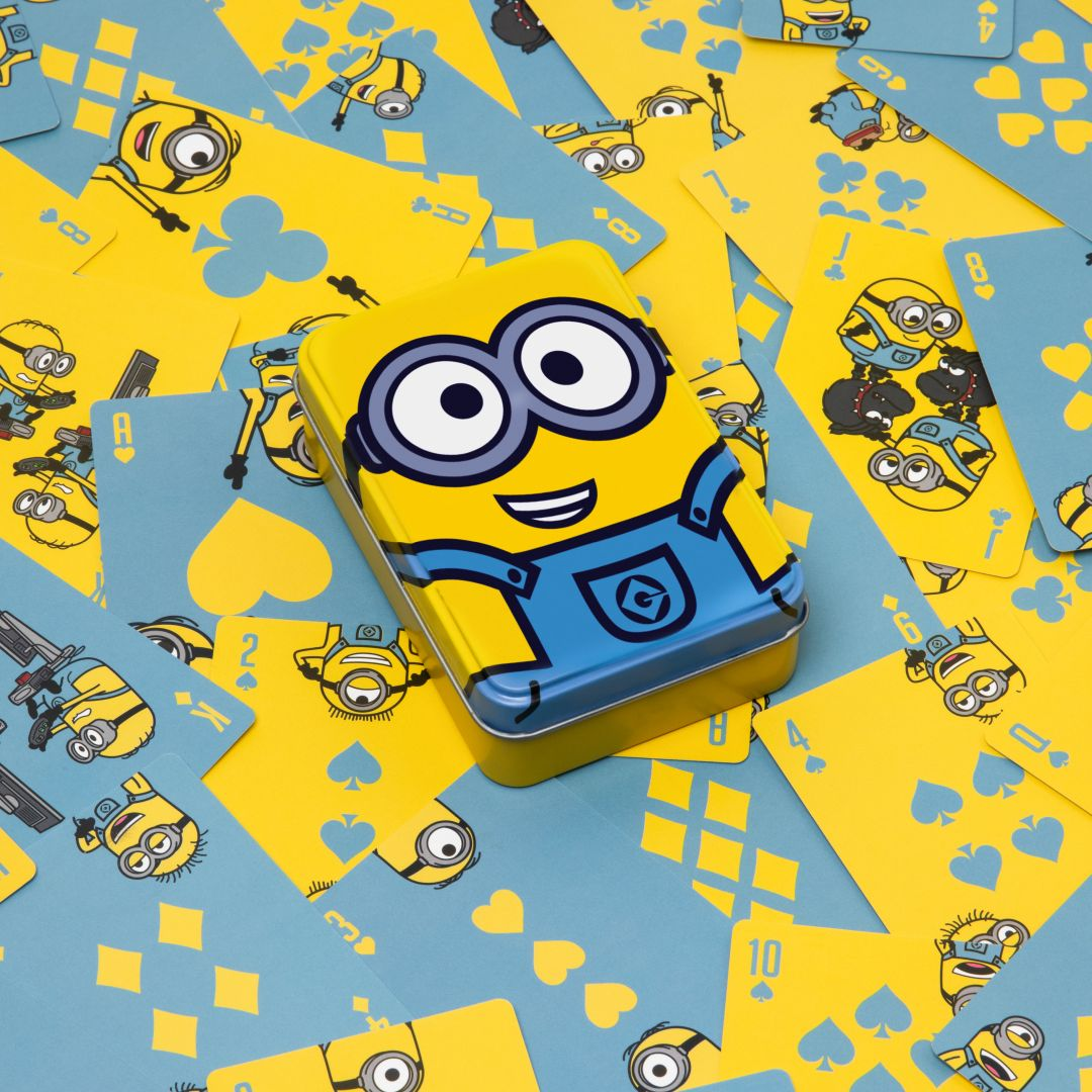 Żółta puszka Minions na niebieskich i żółtych kartach do gry z grafiką Minions.