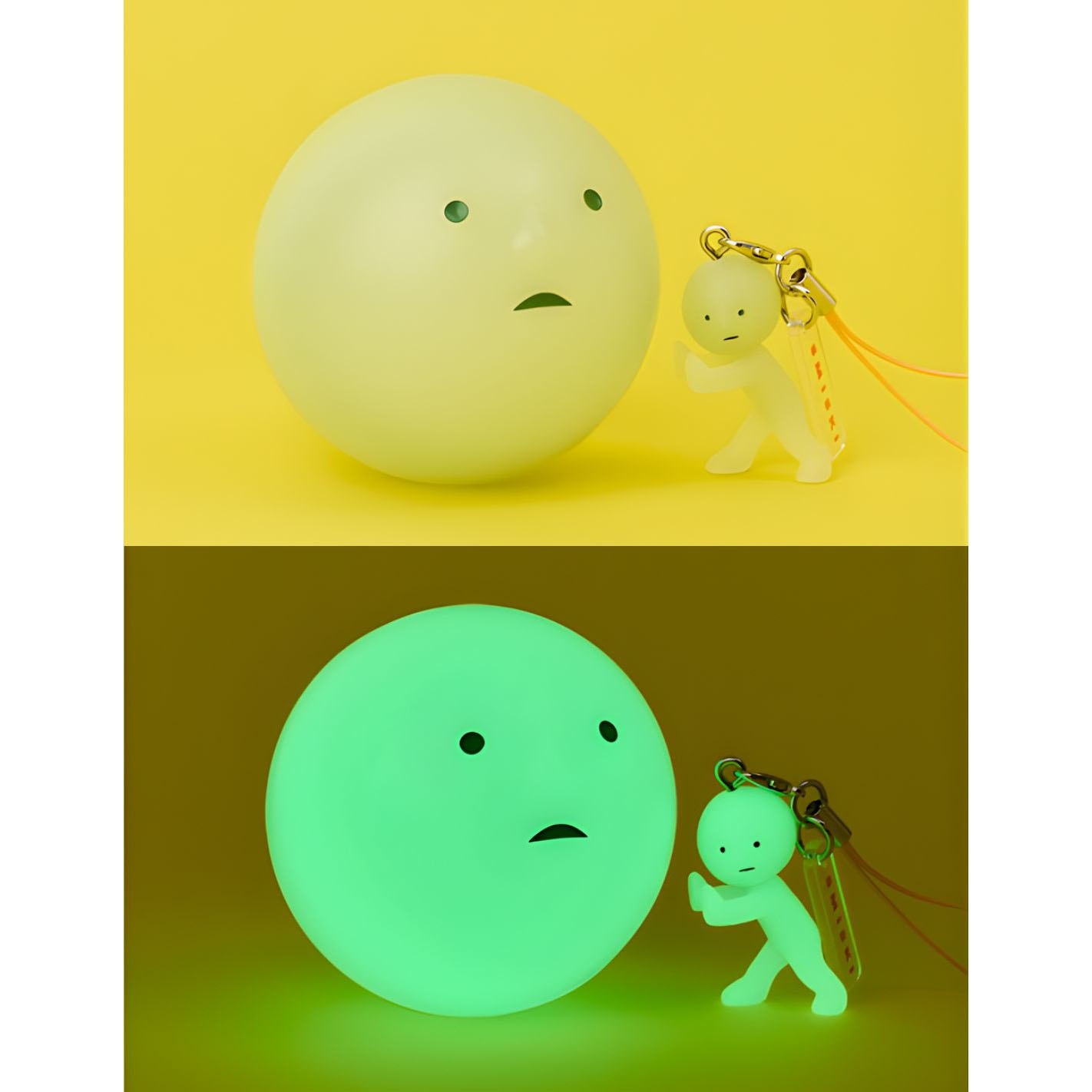 Ein großer, blasser Ballon mit Gesicht und ein kleiner Mann-Schlüsselanhänger auf gelbem Hintergrund.