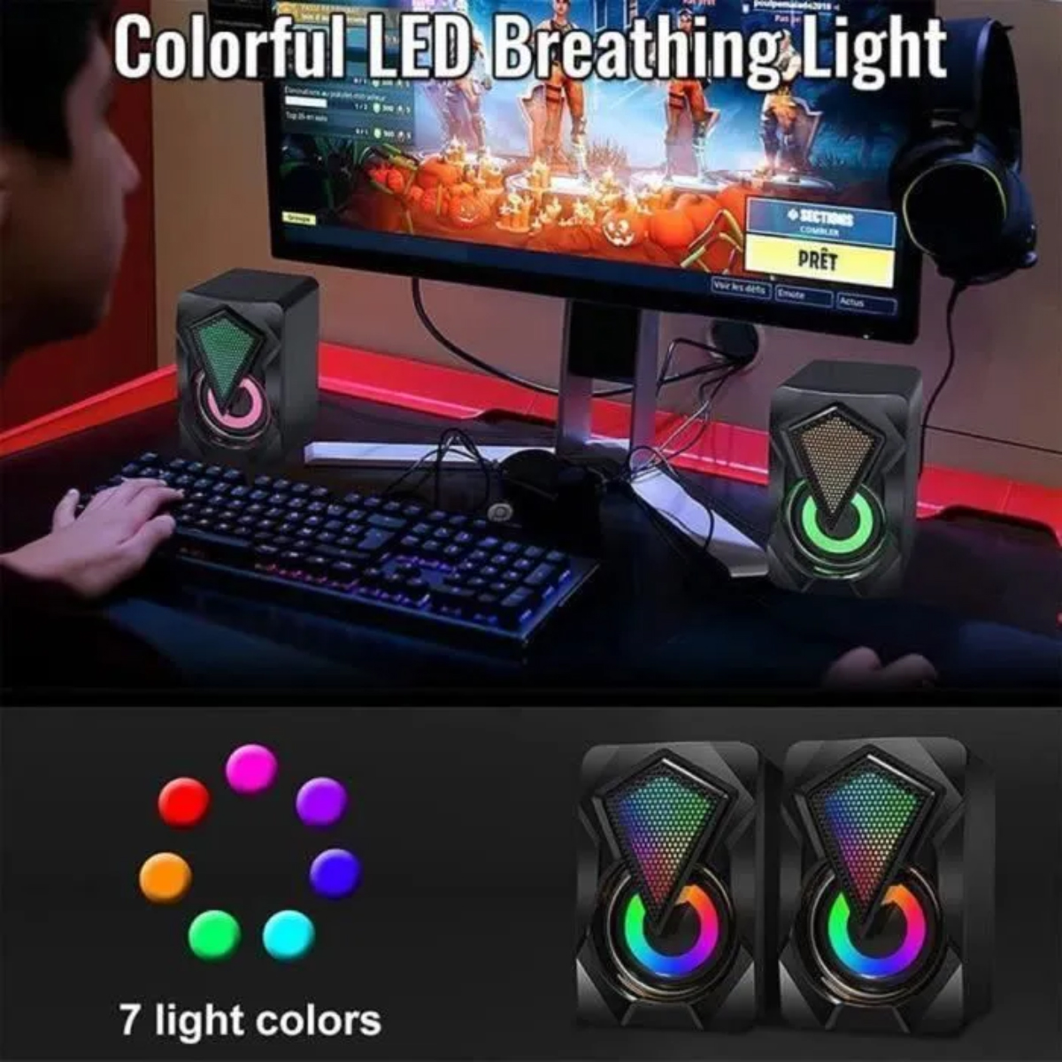 Ein Mann spielt ein Videospiel auf einem Computer mit zwei bunten LED-Lautsprechern.