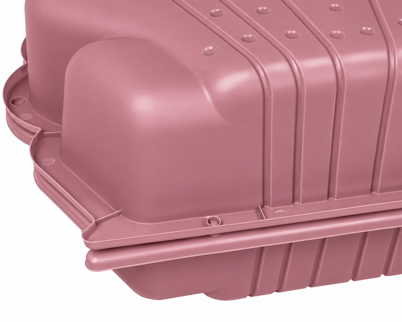 Eine rosafarbene Plastikbox mit gerippter Oberfläche und abgerundeten Kanten.