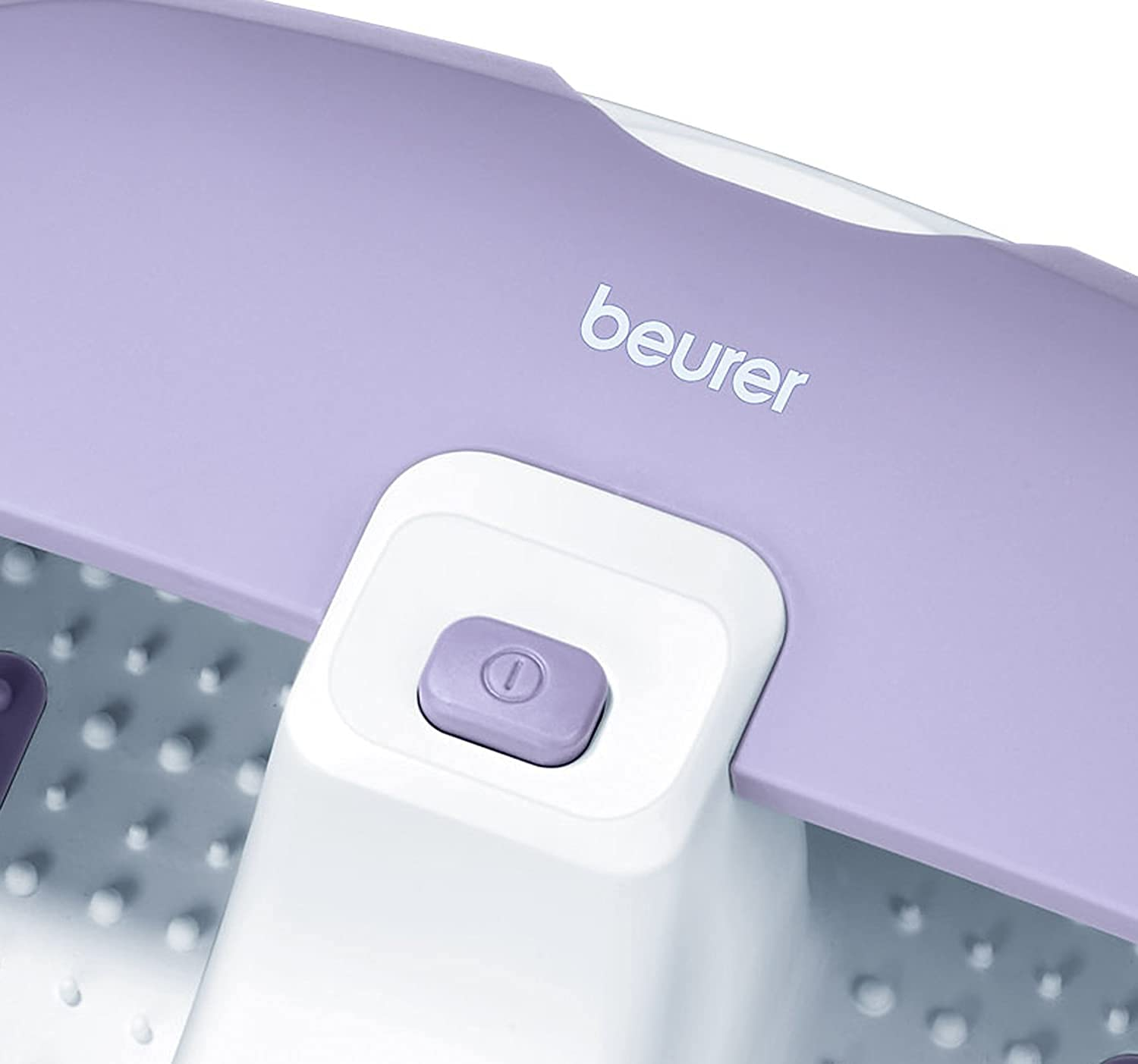 Close-up of a purple Beurer foot bath with a white base and a purple button.