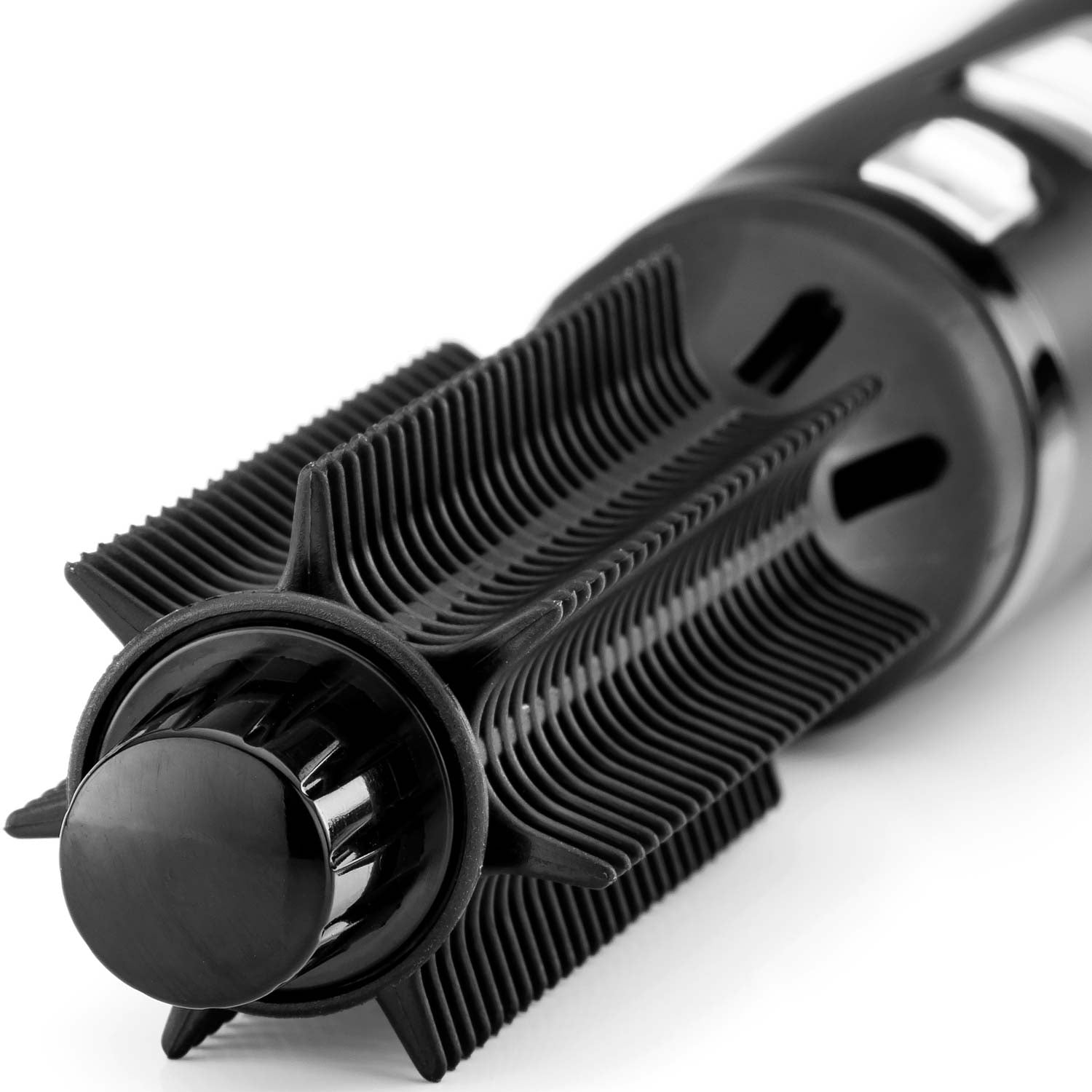 Close-up of a black hair dryer attachment with rotating bristles on a white background.