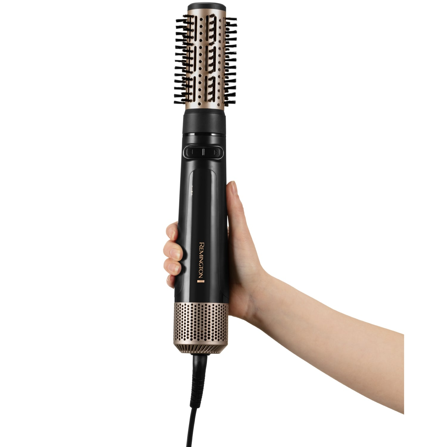 A hand holds a black and gold rotating hot air brush with comb attachment.