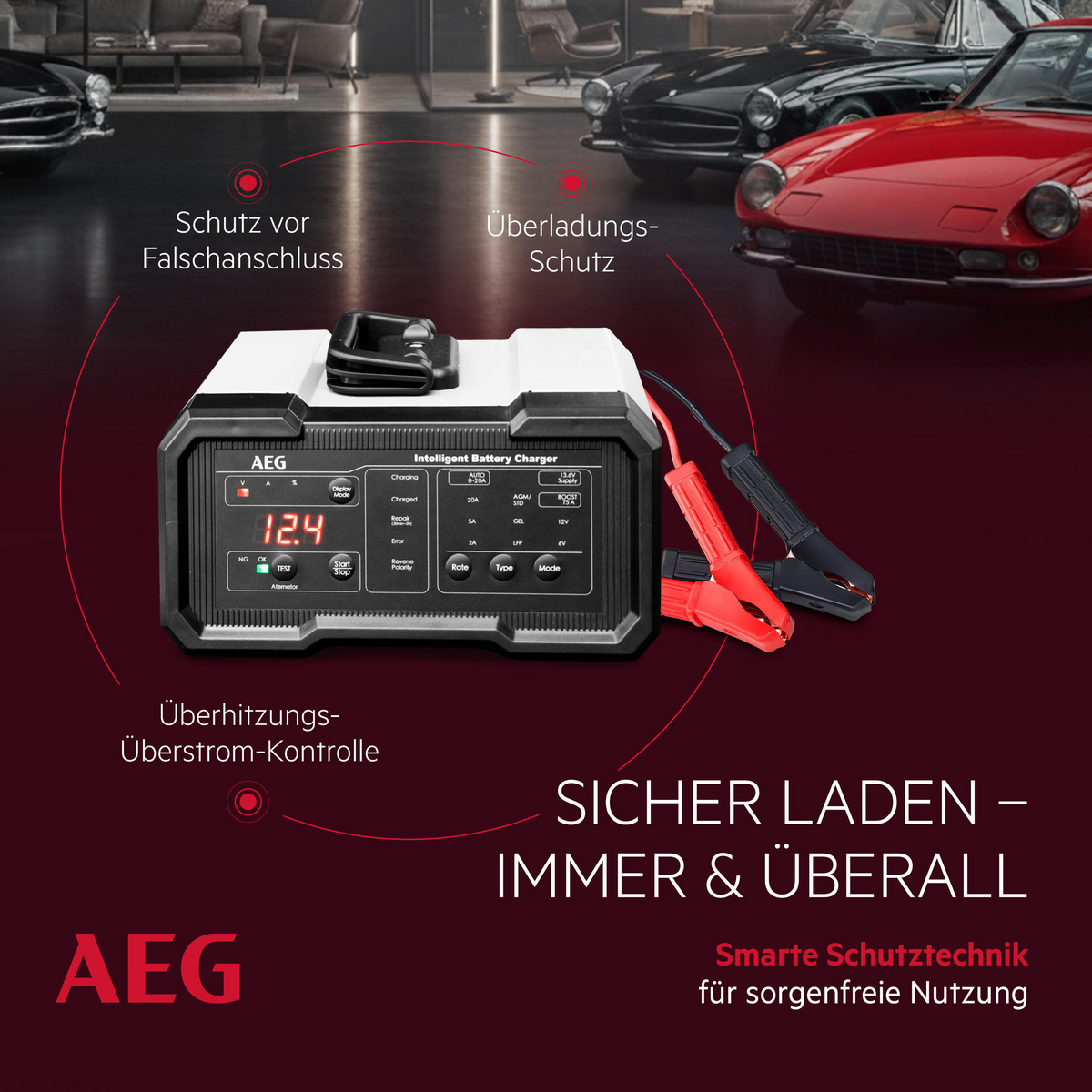 AEG intelligentes Batterieladegerät mit roten und schwarzen Klemmen, vor Autos.