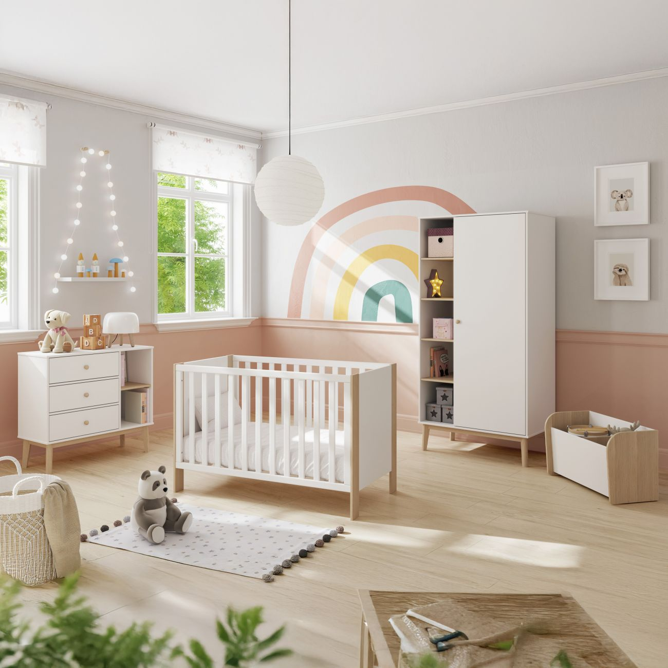 Una habitación infantil blanca con cuna, cómoda, armario y un arcoíris colorido en la pared.